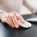 Close-up of female hand with computer mouse. Shallow DOF.