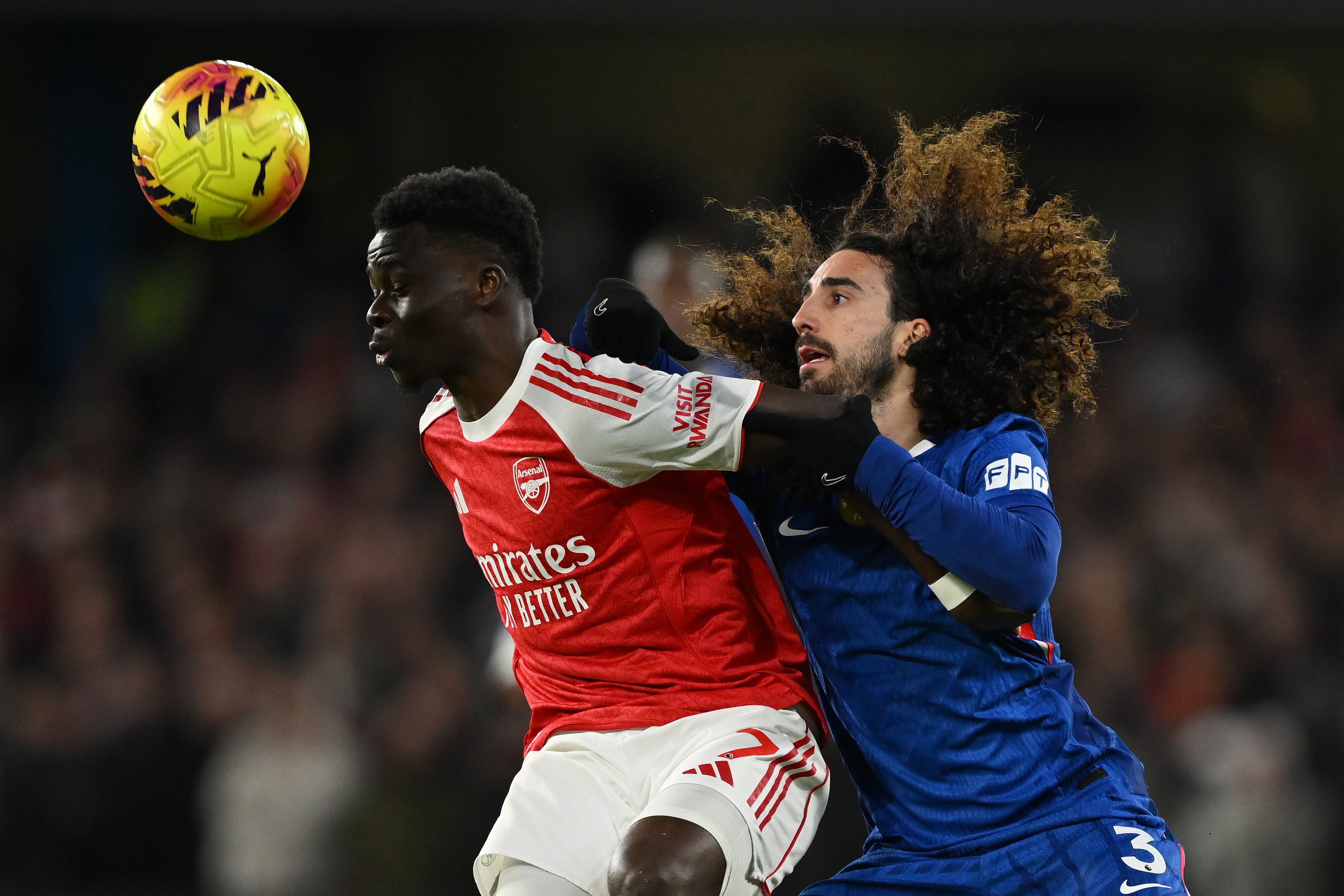 LONDON, ENGLAND - NOVEMBER 30: Bukayo Saka of Arsenal is challenged by Marc Cucurella of Chelsea during the Premier League match between Chelsea and Arsenal at Stamford Bridge on November 30, 2025 in London, England. (Photo by Mike Hewitt/Getty Images)