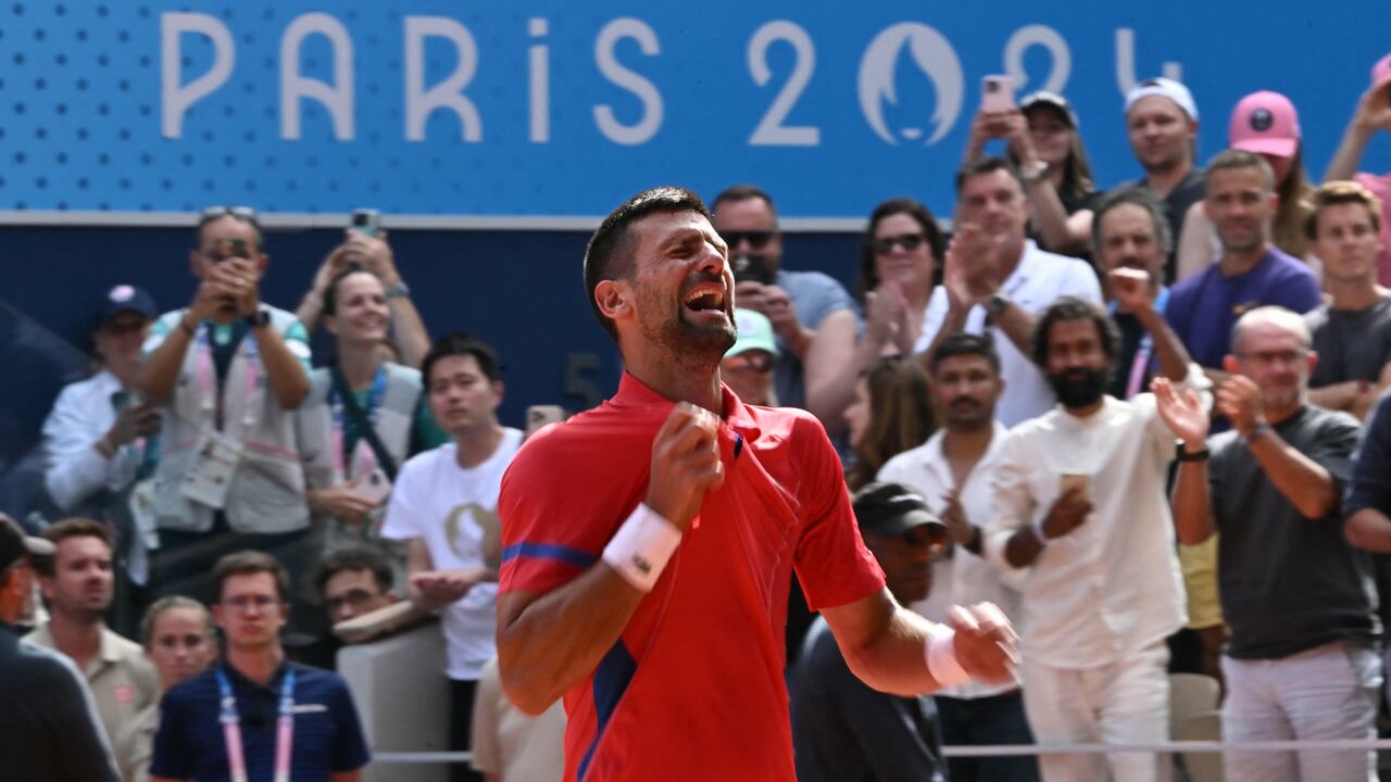 Serbia's Novak Djokovic reacts to beating Spain's Carlos Alcaraz in their men's singles final tennis match on Court Philippe-Chatrier at the Roland-Garros Stadium during the Paris 2024 Olympic Games, in Paris on August 4, 2024. (Photo by CARL DE SOUZA / AFP)