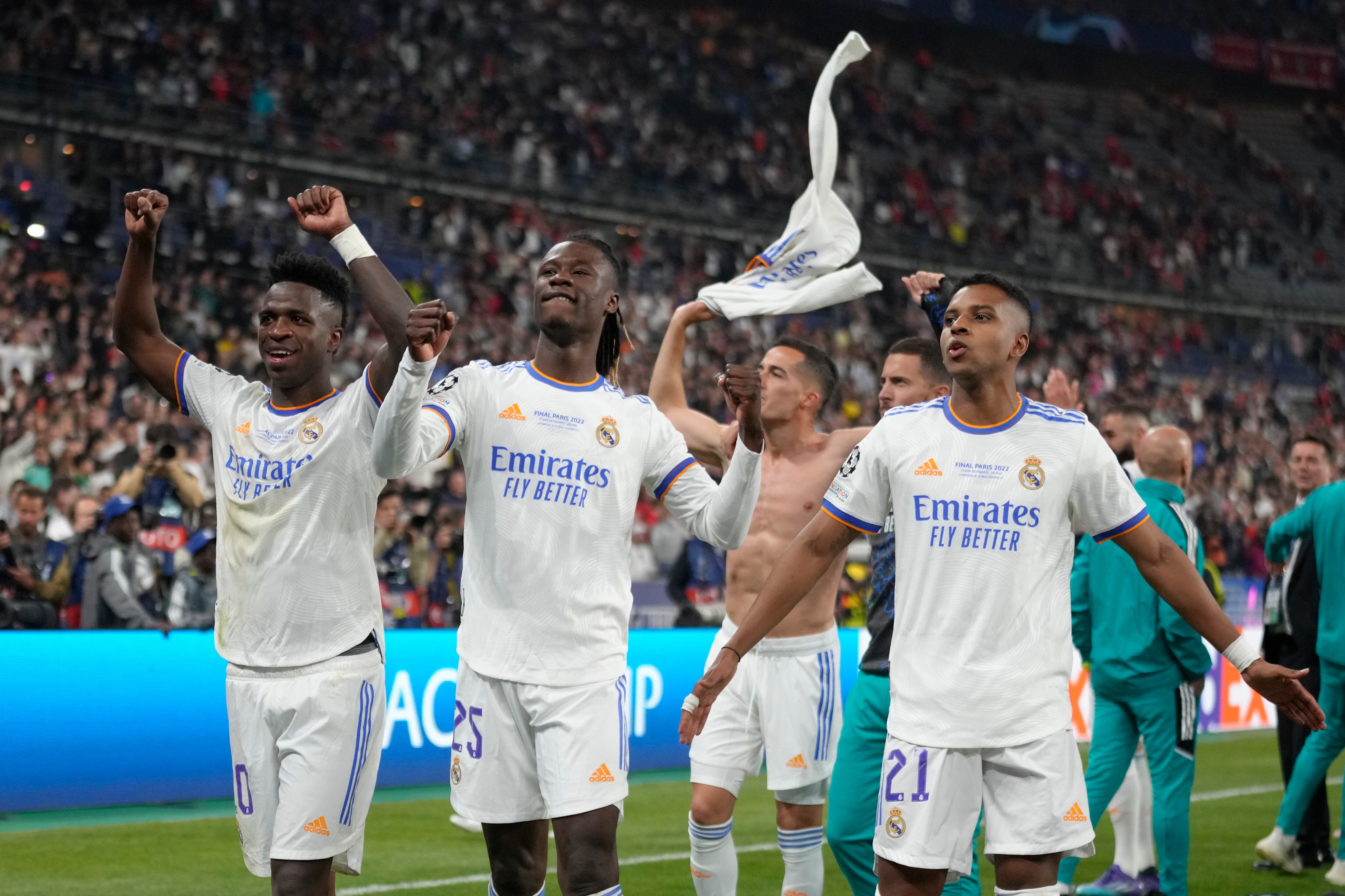 Real Madrid's Rodrygo, right, Real Madrid's Vinicius Junior, left, and Real Madrid's Eduardo Camavinga celebrate winning the Champions League final soccer match between Liverpool and Real Madrid at the Stade de France in Saint Denis near Paris, Saturday, May 28, 2022. Real Madrid won 1-0. (AP Photo/Kirsty Wigglesworth)