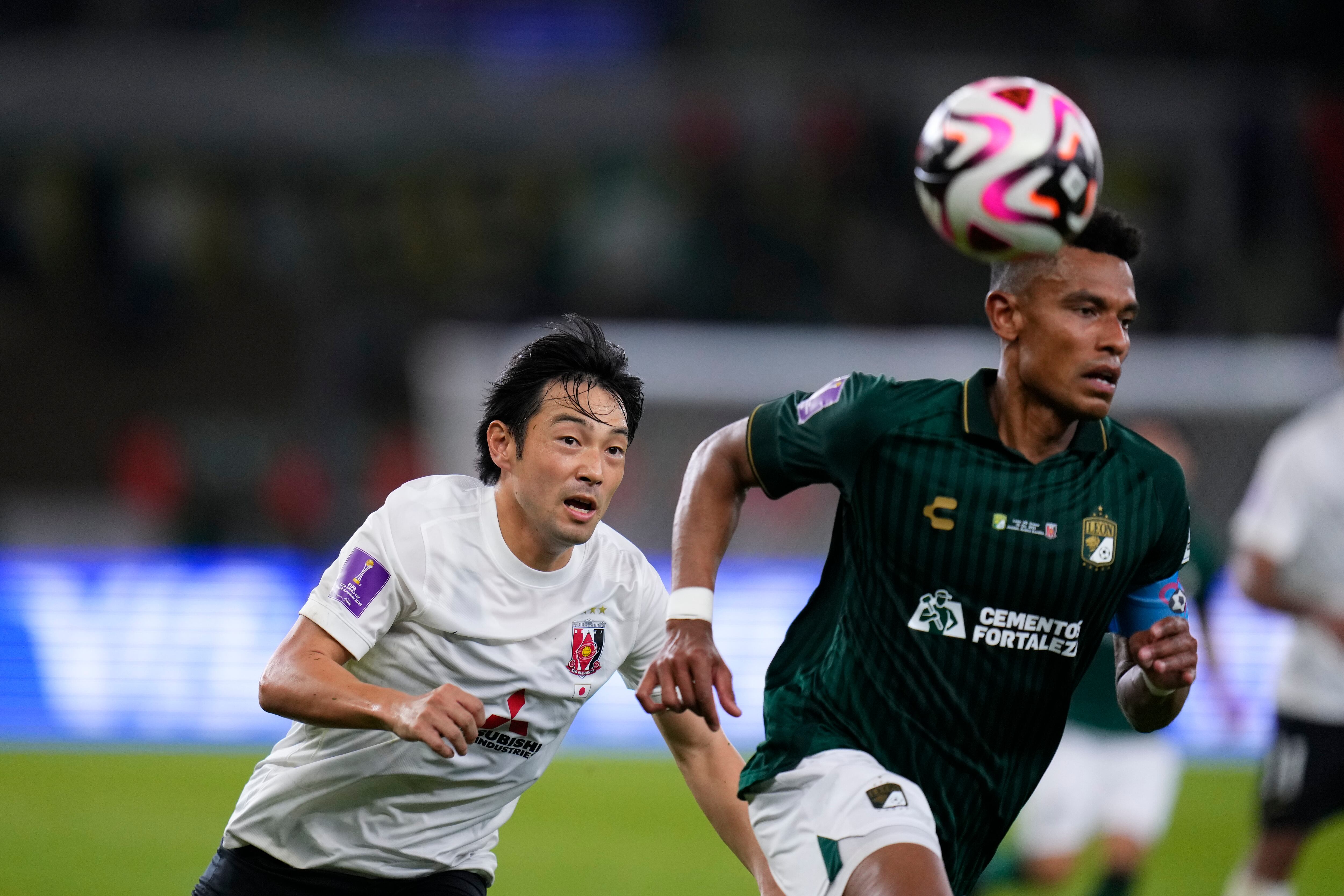 Urawa Reds' Shoya Nakajima, left, and Leon's William Tesillos go for the ball during the Soccer Club World Cup second round soccer match between Club Leon and Urawa Reds at Prince Abdullah Al-Faisal Stadium in Jeddah, Saudi Arabia, Friday, Dec. 15, 2023. (AP Photo/Manu Fernandez)