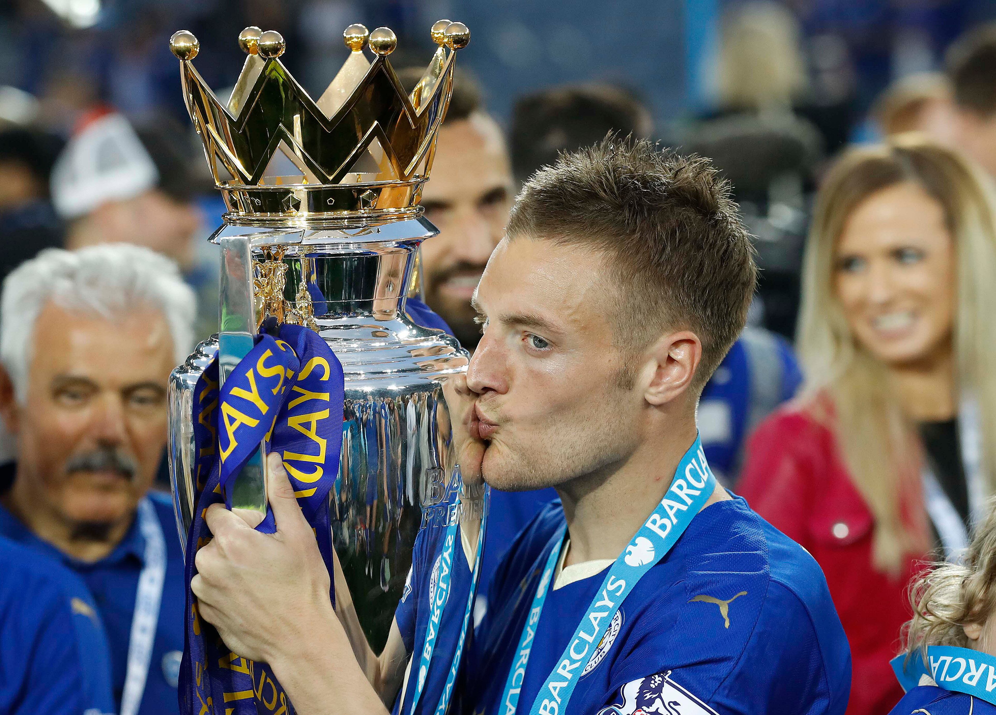 FILE - Leicester's Jamie Vardy kisses the trophy as Leicester City celebrate becoming the English Premier League soccer champions at King Power stadium in Leicester, England, Saturday, May 7, 2016. (AP Photo/Matt Dunham, File)