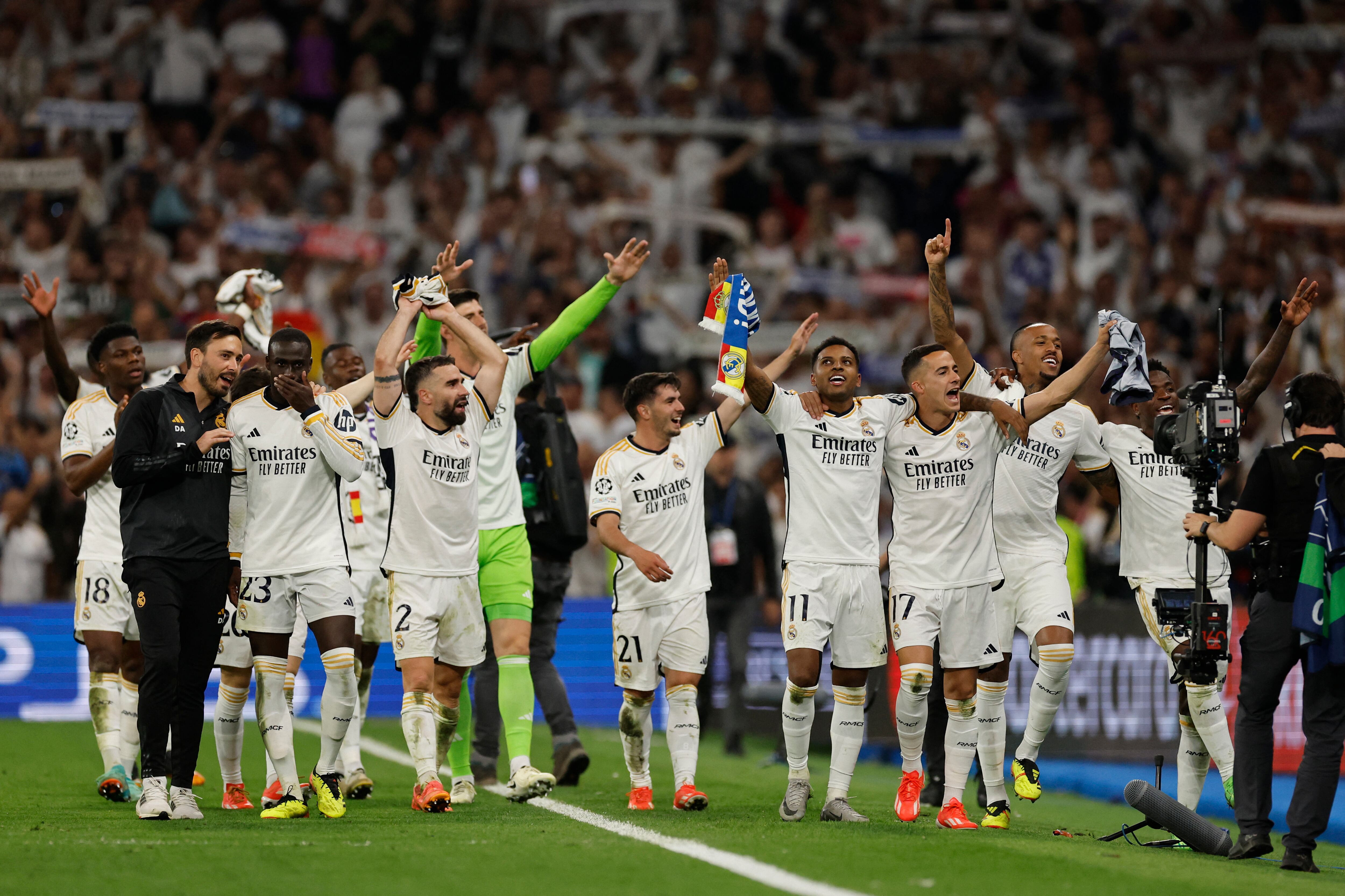Real Madrid's players celebrate victory at the end of the UEFA Champions League semi final second leg football match between Real Madrid CF and FC Bayern Munich at the Santiago Bernabeu stadium in Madrid on May 8, 2024. (Photo by OSCAR DEL POZO / AFP)