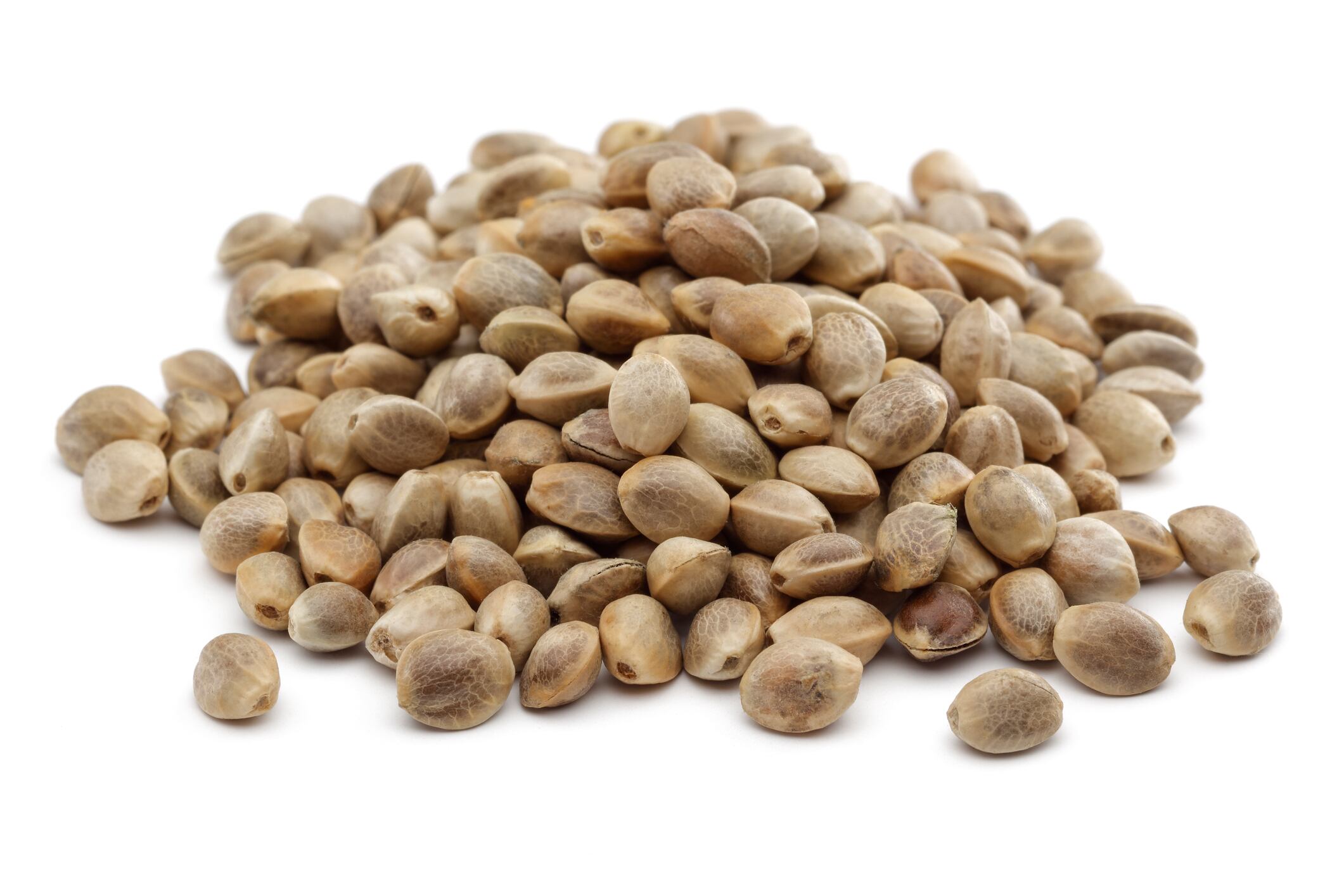 Heap of dry hemp seeds isolated on white background