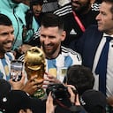 Argentina's forward #10 Lionel Messi celebrates with teammates holding the World Cup Trophy at the end of the Qatar 2022 World Cup final football match between Argentina and France at Lusail Stadium in Lusail, north of Doha on December 18, 2022. (Photo by Jewel SAMAD / AFP)
