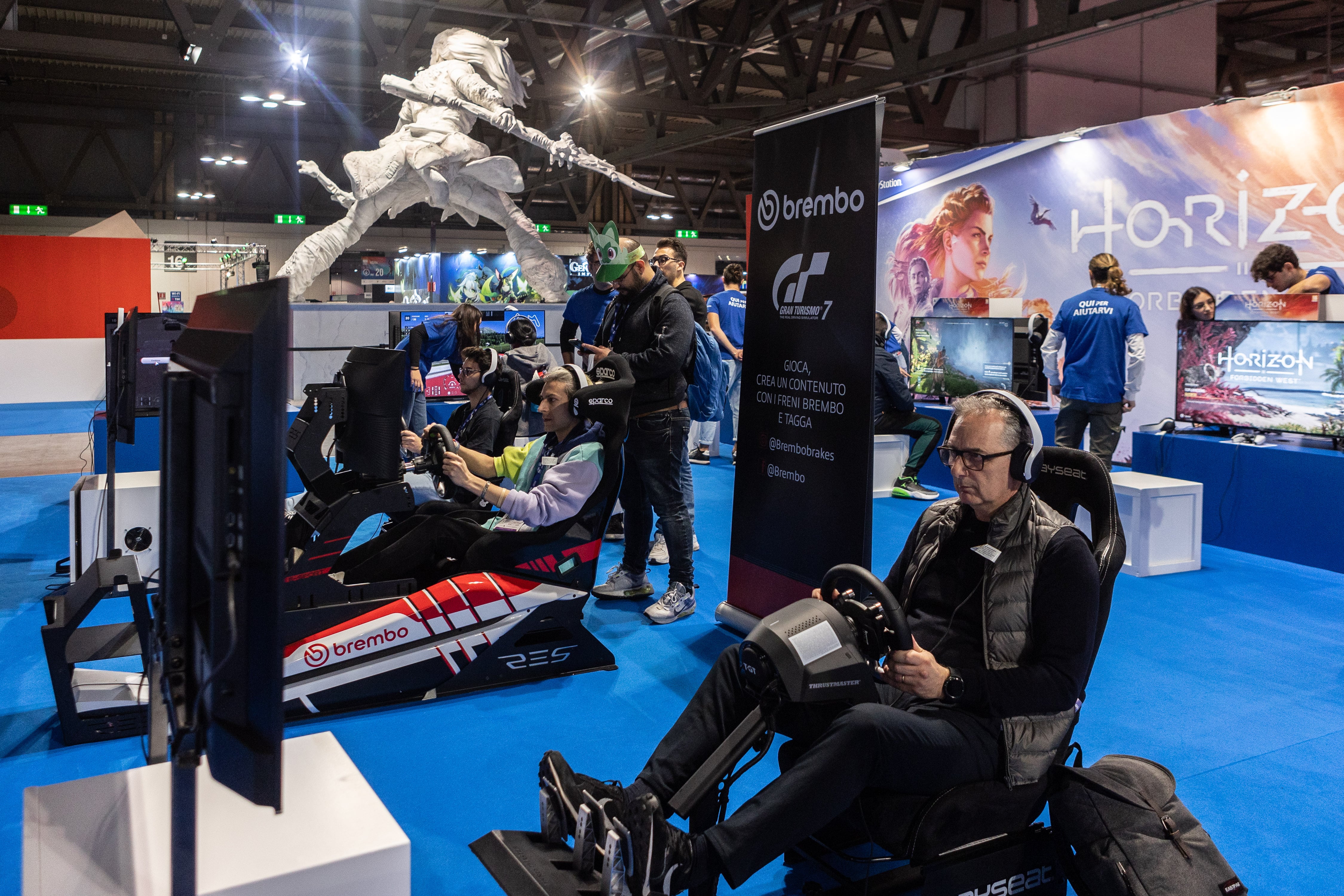 MILAN, ITALY - NOVEMBER 25: Fairgoers play Gran Turismo 7 for PlayStation during the Milan Games Week & Cartoomics 2022 at Fiera Milano Rho on November 25, 2022 in Milan, Italy. Milan Games Week & Cartoomics is the most complete Italian event dedicated to video games, esports, digital entertainment and geek culture, cosplayers, comics, publishing and entertainment. (Photo by Emanuele Cremaschi/Getty Images)