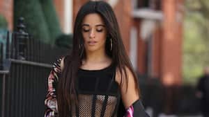 LONDON, ENGLAND - MARCH 24: Camila Cabello is seen wearing Dries van Noten suit with floral print & flared pants in black, Dion Lee black sheer top, black heeled shoes on March 24, 2022 in London, England. (Photo by Christian Vierig/GC Images)