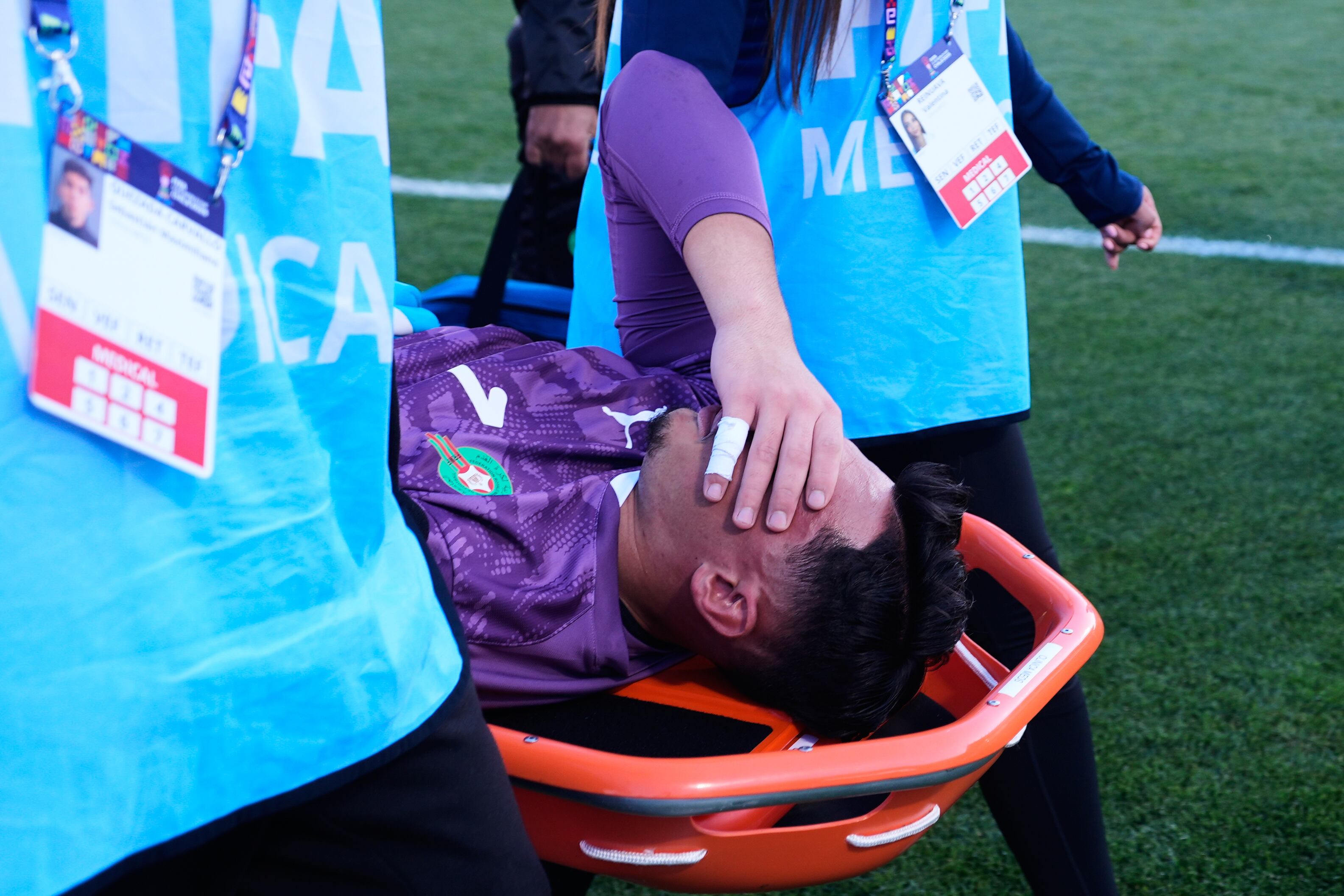 Paramedics carry Morocco's goalkeeper Yanis Benchaouch off the field during a FIFA U-20 World Cup semifinal soccer match against France at Elias Figueroa Brander Stadium in Valparaiso, Chile, Wednesday, Oct. 15, 2025. (AP Photo/Matias Delacroix)
