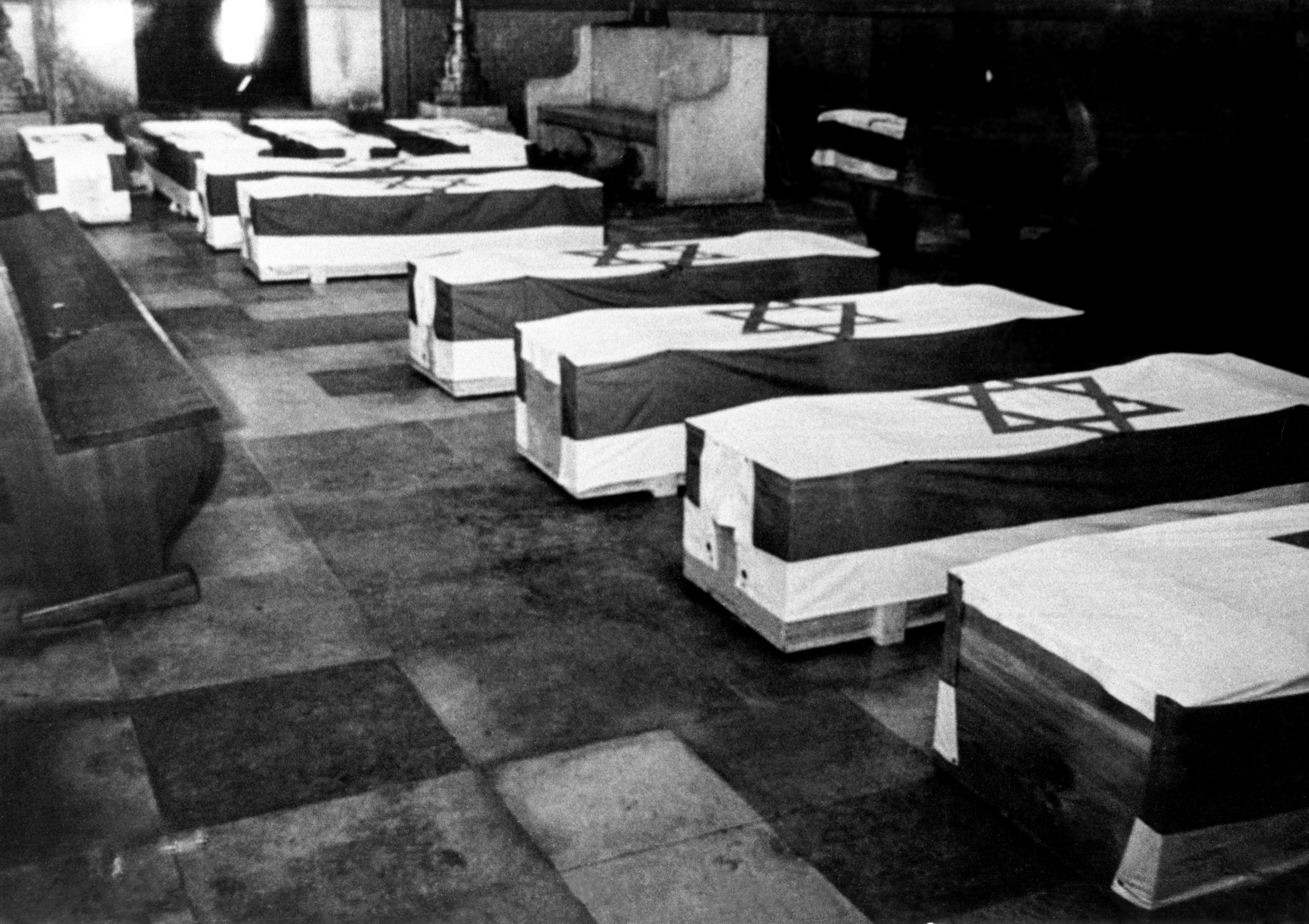 The remains of the victims of the Arabian terrorist attack from 5 September 1972 on the Israeli Olympic team are laid out in the Munich synagog. An Israeli flag covers each of the coffins. Arabian terrorists of the group 'Black September' had attacked the Israeli accommodation in the Olympic village, killed two Israelis and took nine hostages in the morning of 5th September. Their ultimatum: release of 200 imprisoned Palestinians and free passage with the other hostages. In the night of 6th September, the rescue operation at the military airport Fürstenfeldbruck fails. All nine hostages, five terrorists, and a Munich police officer lose their lives during the operation. (Photo by dpa/picture alliance via Getty Images)