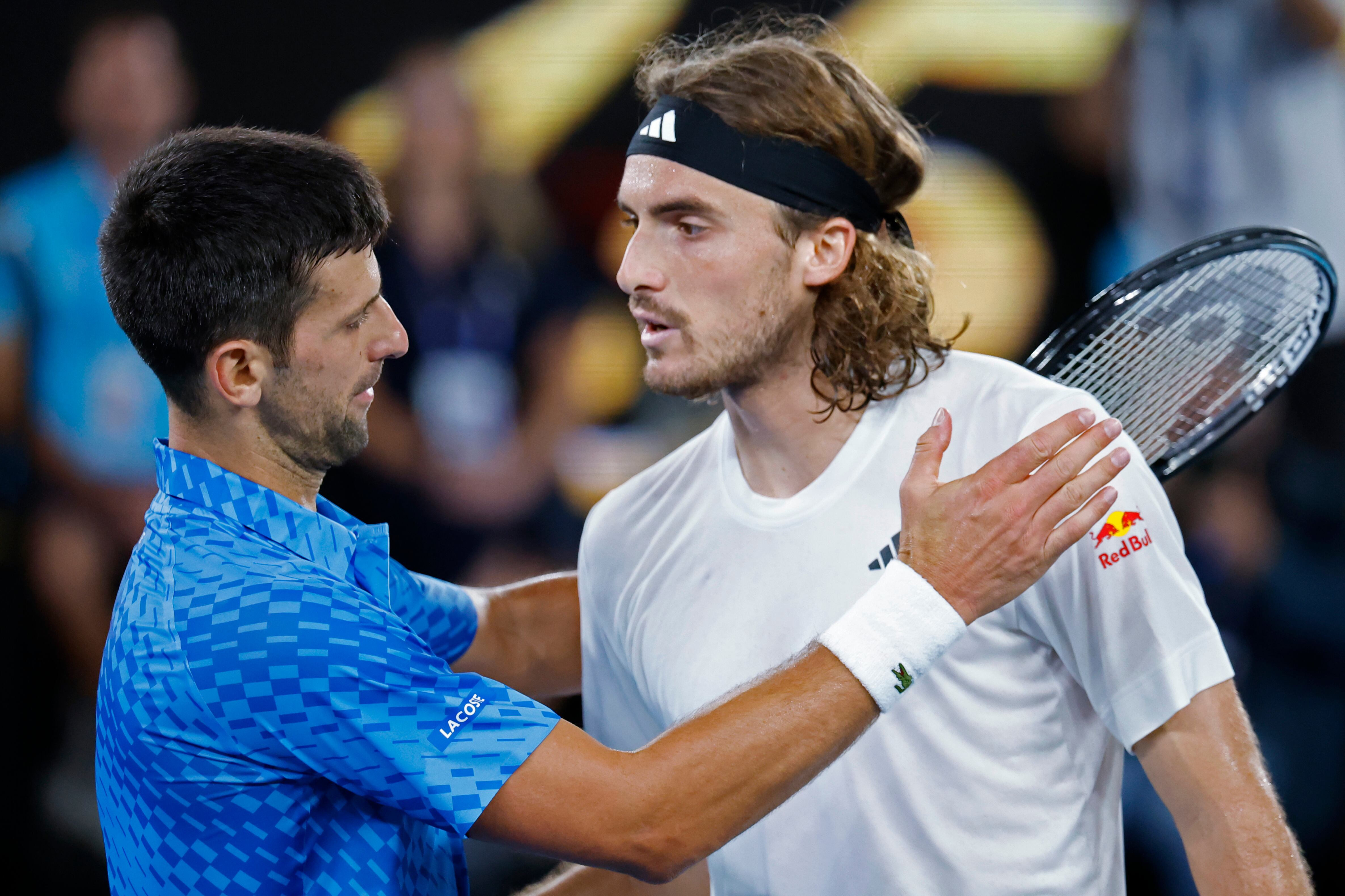 Novak Djokovic of Serbia, left, meets Stefanos Tsitsipas of Greece at the net after Djokovic won the men's singles final at the Australian Open tennis championships in Melbourne, Australia, Sunday, Jan. 29, 2023. (AP Photo/Asanka Brendon Ratnayake)