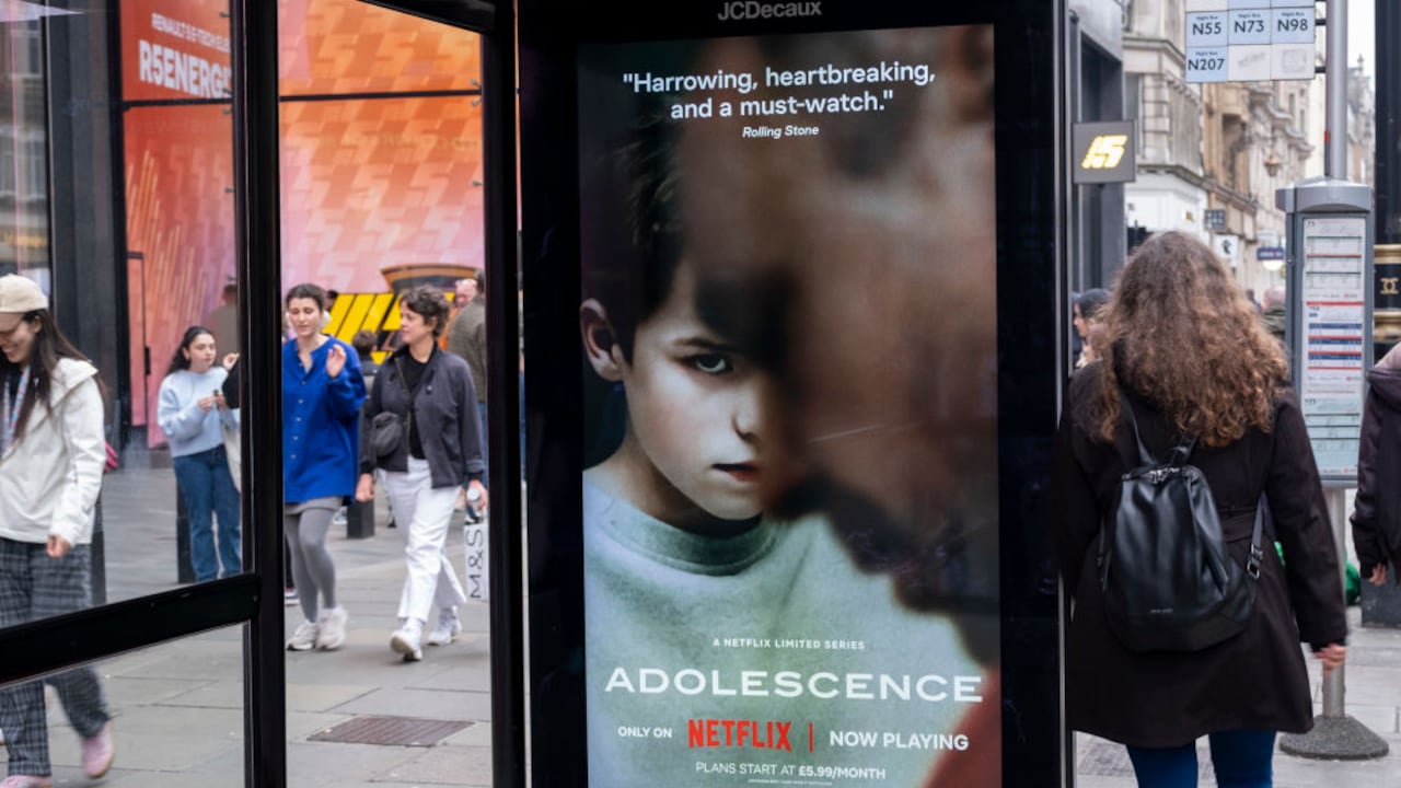 Passing people interacting with an advertising poster on a bus shelter for the Netflix drama 'Adolescence', the story of which is sparking conversations in public and govenrment around the subject of toxic masculinity and children's access to dangerous and misoginistic content on the internet and social media on 23rd March 2025 in London, United Kingdom. (photo by Mike Kemp/In Pictures via Getty Images)