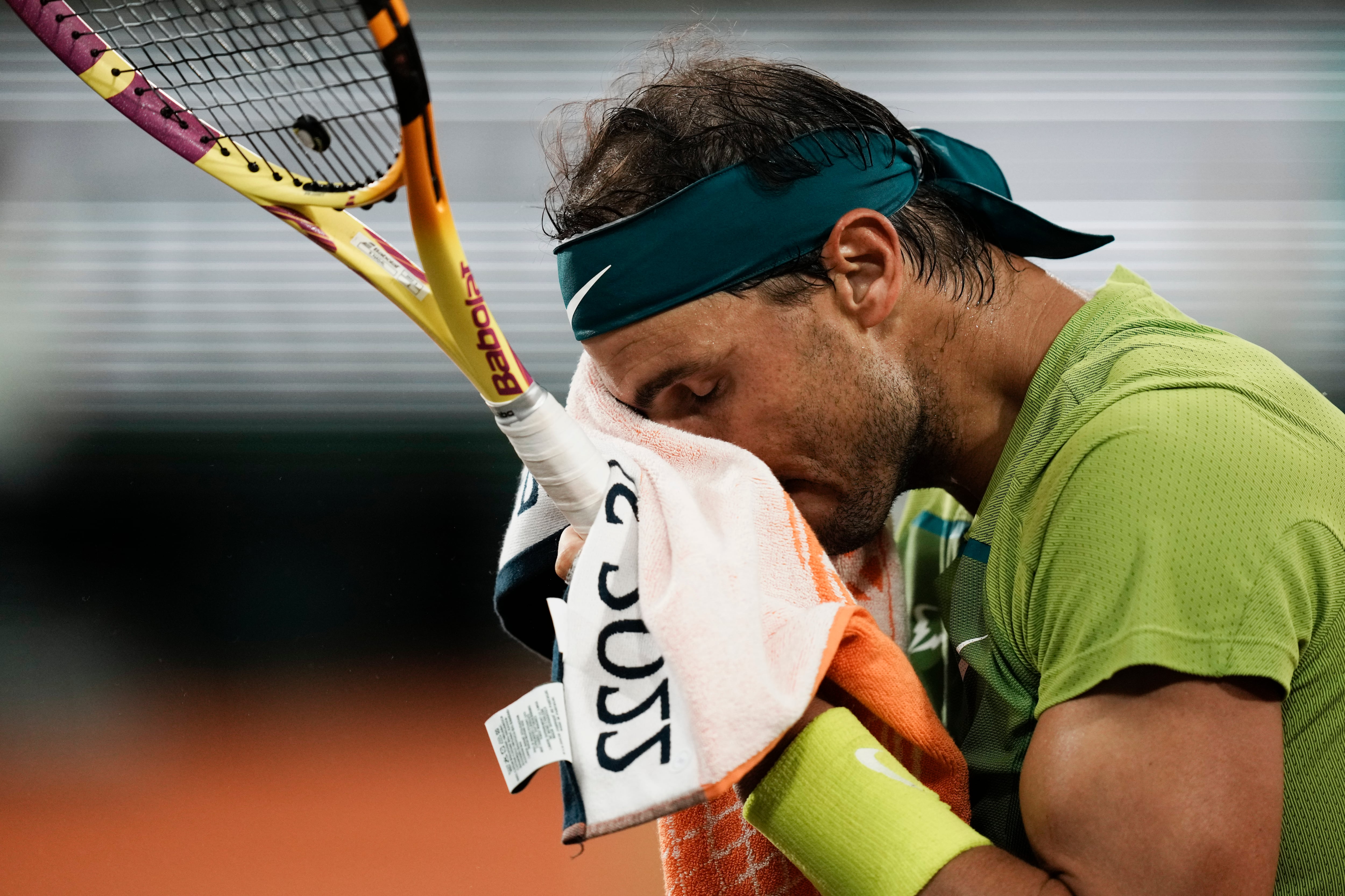 Spain's Rafael Nadal wipes the sweat off his face during their semifinal match at the French Open tennis tournament in Roland Garros stadium in Paris, France, Friday, June 3, 2022. (AP Photo/Thibault Camus)