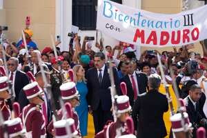 Venezuelan President Nicolas Maduro and his wife Cilia Flores arrive at the National Assembly for his swear-in ceremony for a third term in Caracas, Venezuela, Friday, Jan. 10, 2025. (AP Photo/Matias Delacroix)