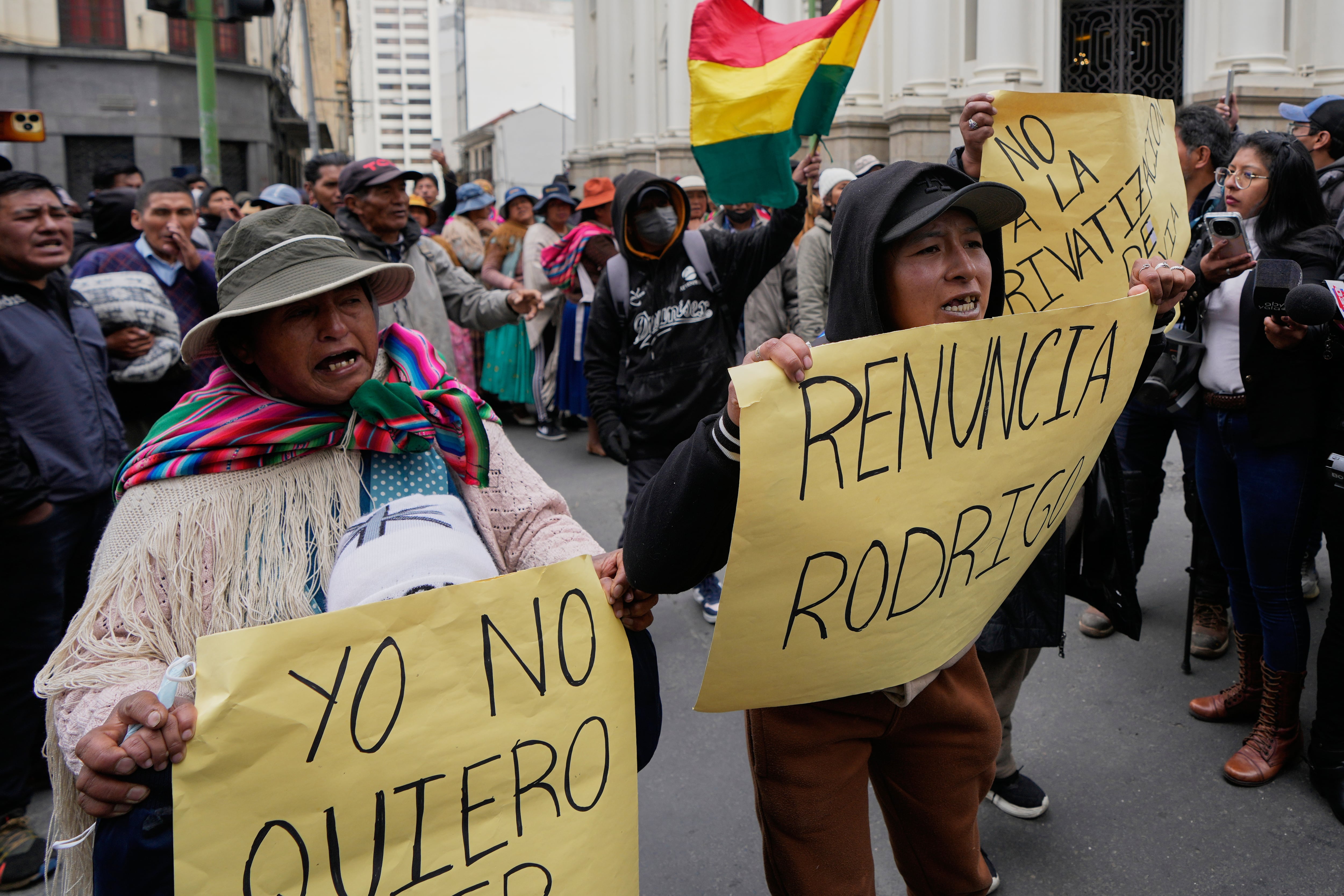 Manifestantes contrarios al gobierno sostienen carteles pidiendo la renuncia del presidente, Rodrigo Paz, en La Paz, Bolivia.