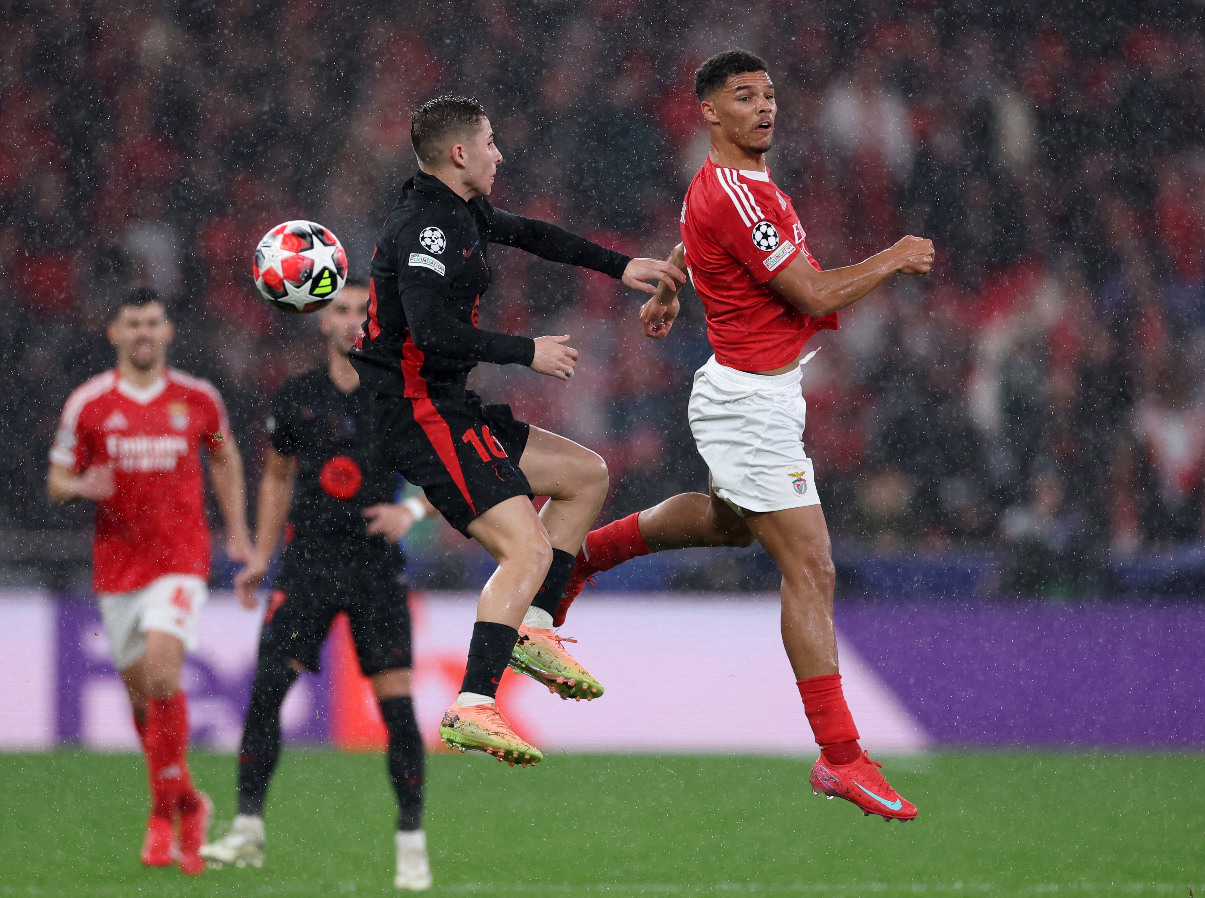 Barcelona's Spanish midfielder #16 Fermin Lopez fights for the ball with Benfica's Danish defender #06 Alexander Bah during the UEFA Champions League, league phase football match between SL Benfica and FC Barcelona at Luz stadium in Lisbon on January 21, 2025. (Photo by FILIPE AMORIM / AFP)