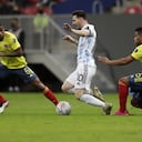 Argentina's Lionel Messi, center, and Colombia's Frank Fabra, right, battle for the ball during a Copa America semifinal soccer match at the National stadium in Brasilia, Brazil, Tuesday, July 6, 2021. (AP Photo/Eraldo Peres)