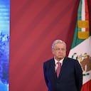 (FILES) In this file photo taken on December 08, 2020 Mexican President Andres Manuel Lopez Obrador stands next to the Mexican flag before his daily press conference at the Palacio Nacional in Mexico City. - Mexican President Andres Manuel Lopez Obrador, who recovers from the coronavirus, will resume his regular activities in a few days, his interior minister said on January 29, 2021. (Photo by ALFREDO ESTRELLA / AFP)