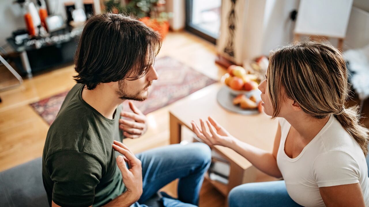 Couple have relationship issues, arguing and fighting in living room