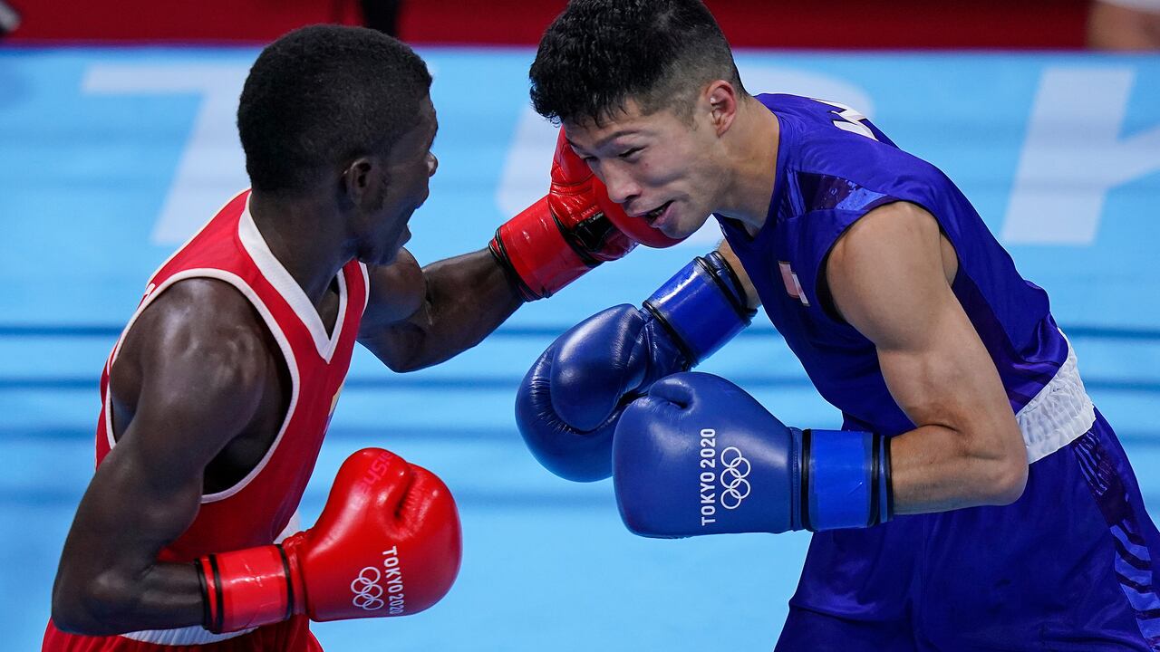 Colombia's Yuberjen Herney Martinez Rivas, right, exchanges punches with Japan's Ryomei Tanaka in their men's flyweight 52-kg quarterfinal boxing match at the 2020 Summer Olympics, Tuesday, Aug. 3, 2021, in Tokyo, Japan. (AP Photo/Themba Hadebe)