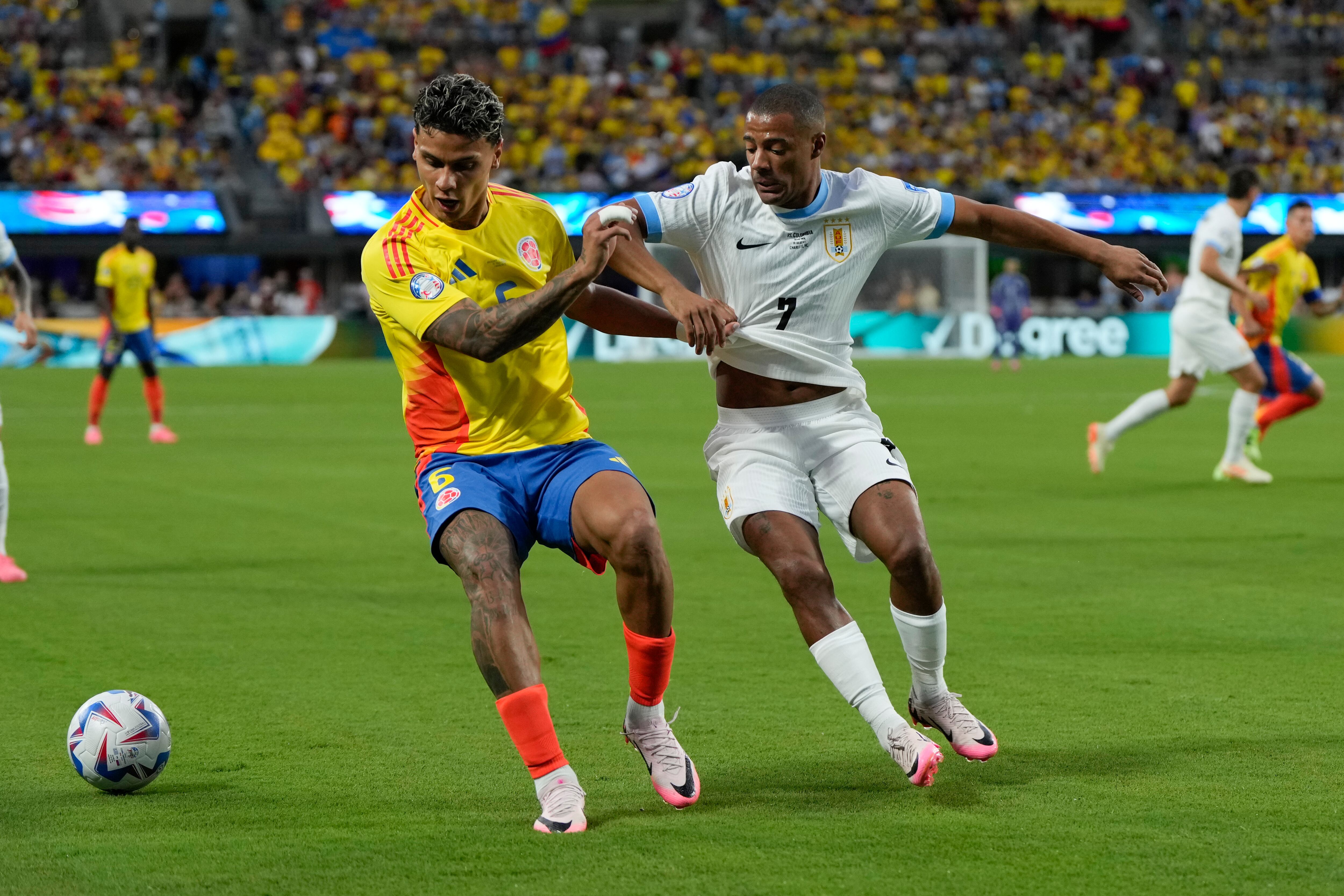 Richard Ríos de Colombia, izquierda, y Nicolás De La Cruz de Uruguay luchan por el balón durante un partido de fútbol semifinal de la Copa América en Charlotte, Carolina del Norte, el miércoles 10 de julio de 2024. (Foto AP/Julia Nikhinson)