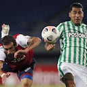 Uruguay's Nacional Guzman Corujo (L) falls next to Colombia's Atletico Nacional Jefferson Duque during their Copa Libertadores football tournament group stage match at the Hernan Ramirez Villegas in Pereira, Colombia, on May 12, 2021.