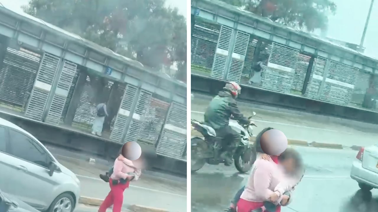 Mujer vista atravesando la carrera 30 en Bogotá este miércoles, 7 de octubre, con una menor de edad en sus brazos.
