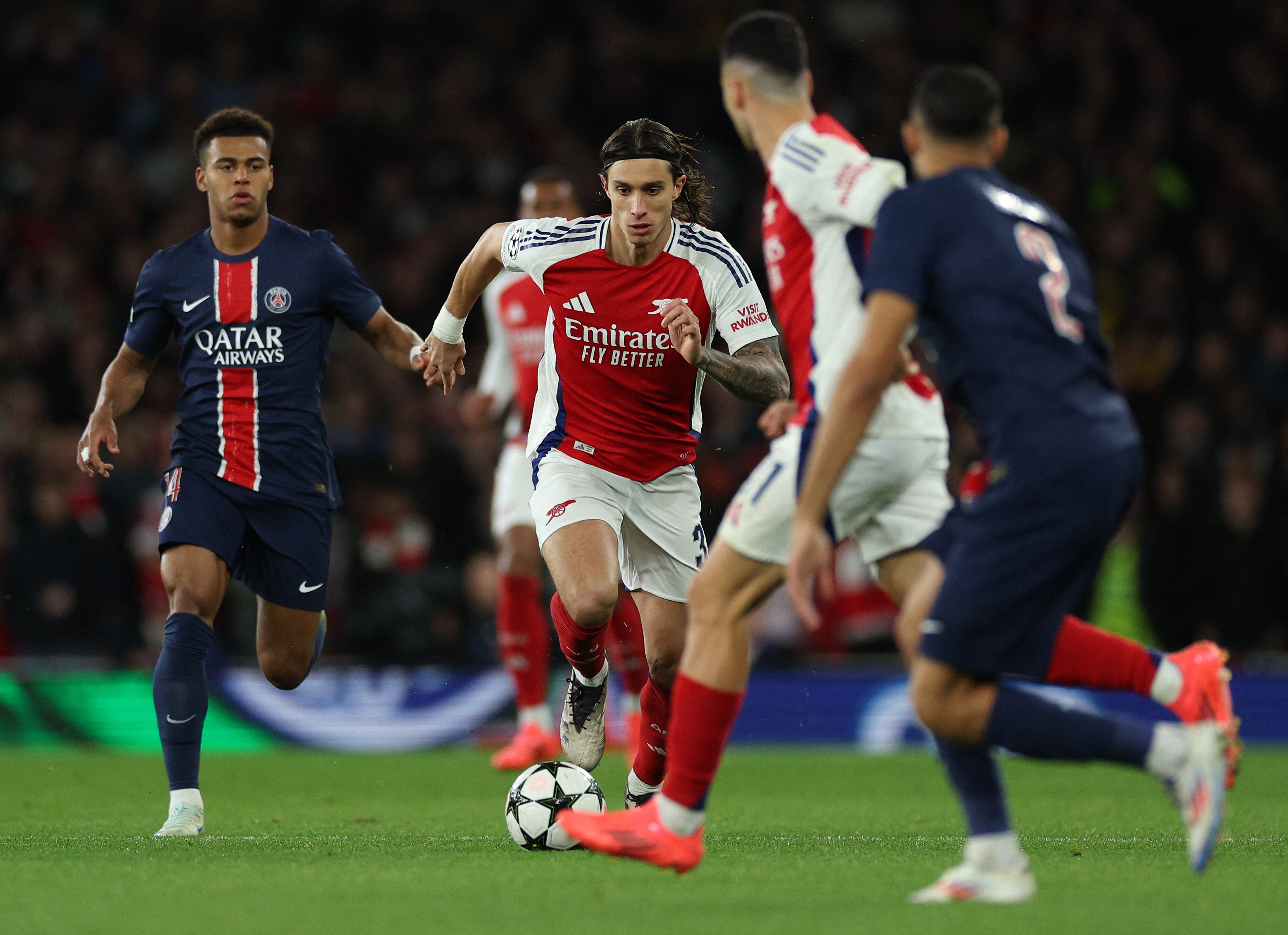 Arsenal's Italian defender #33 Riccardo Calafiori runs with the ball during the UEFA Champions League football match between Arsenal and Paris Saint-Germain (PSG) at the Emirates Stadium in north London on October 1, 2024. (Photo by Adrian Dennis / AFP)