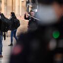 Members of the judiciary police stand in a hall at Paris' Gare du Nord train station, after several people were lightly wounded by a man wielding a knife on January 11, 2023. - The man was arrested by police at the station, which serves as a hub for trains to London and northern Europe, after they opened fire and wounded him, said a police source, who asked not to be named. (Photo by JULIEN DE ROSA / AFP)