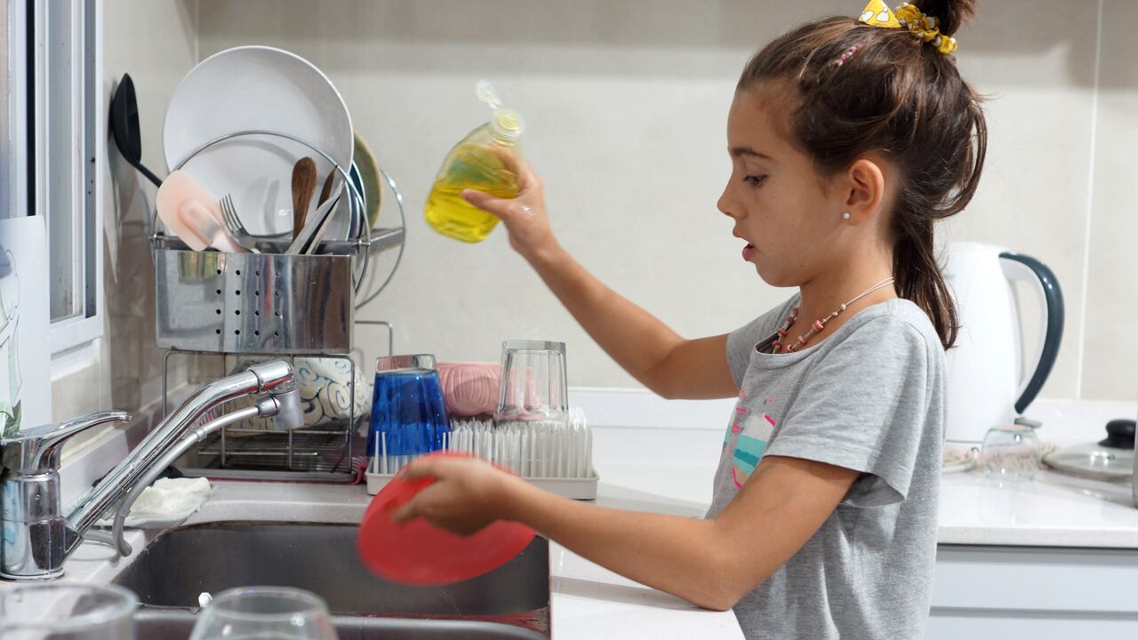 girl washing crockery in the kitchen