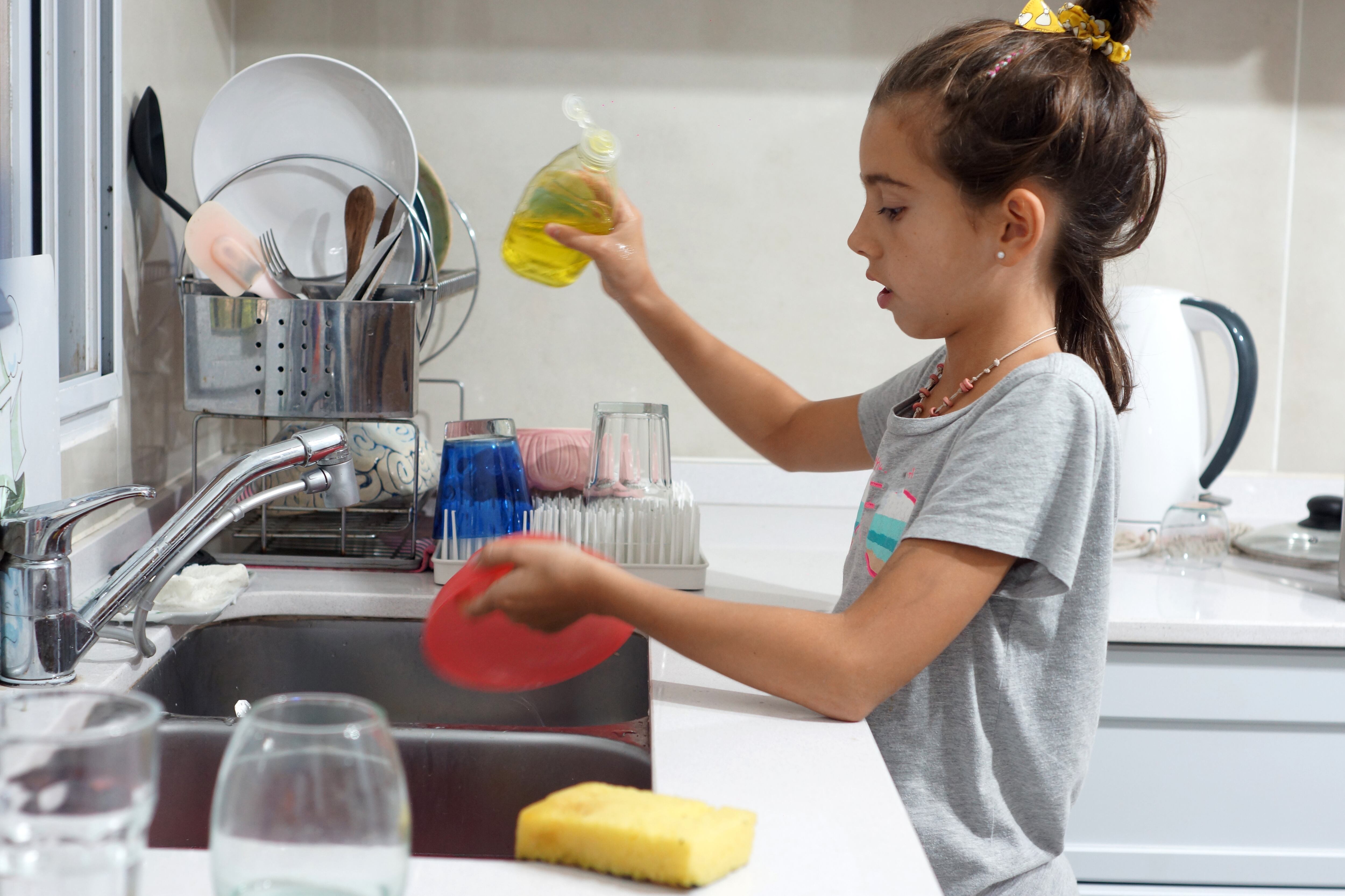 girl washing crockery in the kitchen