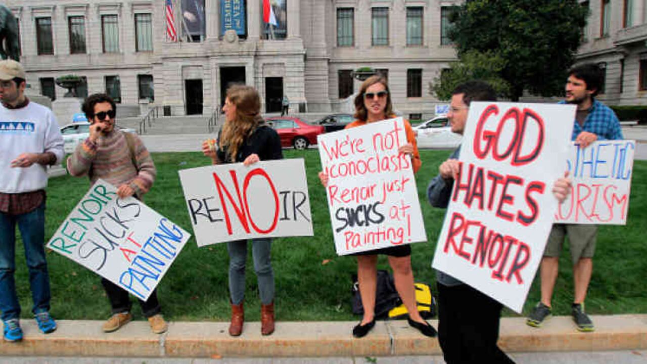 Algunos miembros del movimiento protestan a la entrada del museo de Bellas Artes de Boston. En los carteles se puede leer “Renoir apesta como pintor”, “Dios odia a Renoir” y “Terrorismo estético”.