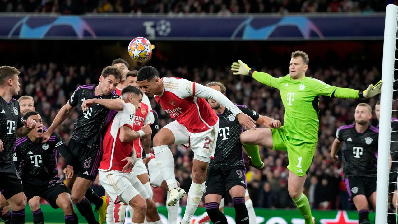 Arsenal's Martin Odegaard, center, celebrates after Bukayo Saka scored the opening goal during the Champions League quarter final first leg soccer match between Arsenal and Bayern Munich at the Emirates Stadium, London, Tuesday, April 9, 2024. (AP Photo/Frank Augstein)