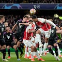 Arsenal's Martin Odegaard, center, celebrates after Bukayo Saka scored the opening goal during the Champions League quarter final first leg soccer match between Arsenal and Bayern Munich at the Emirates Stadium, London, Tuesday, April 9, 2024. (AP Photo/Frank Augstein)