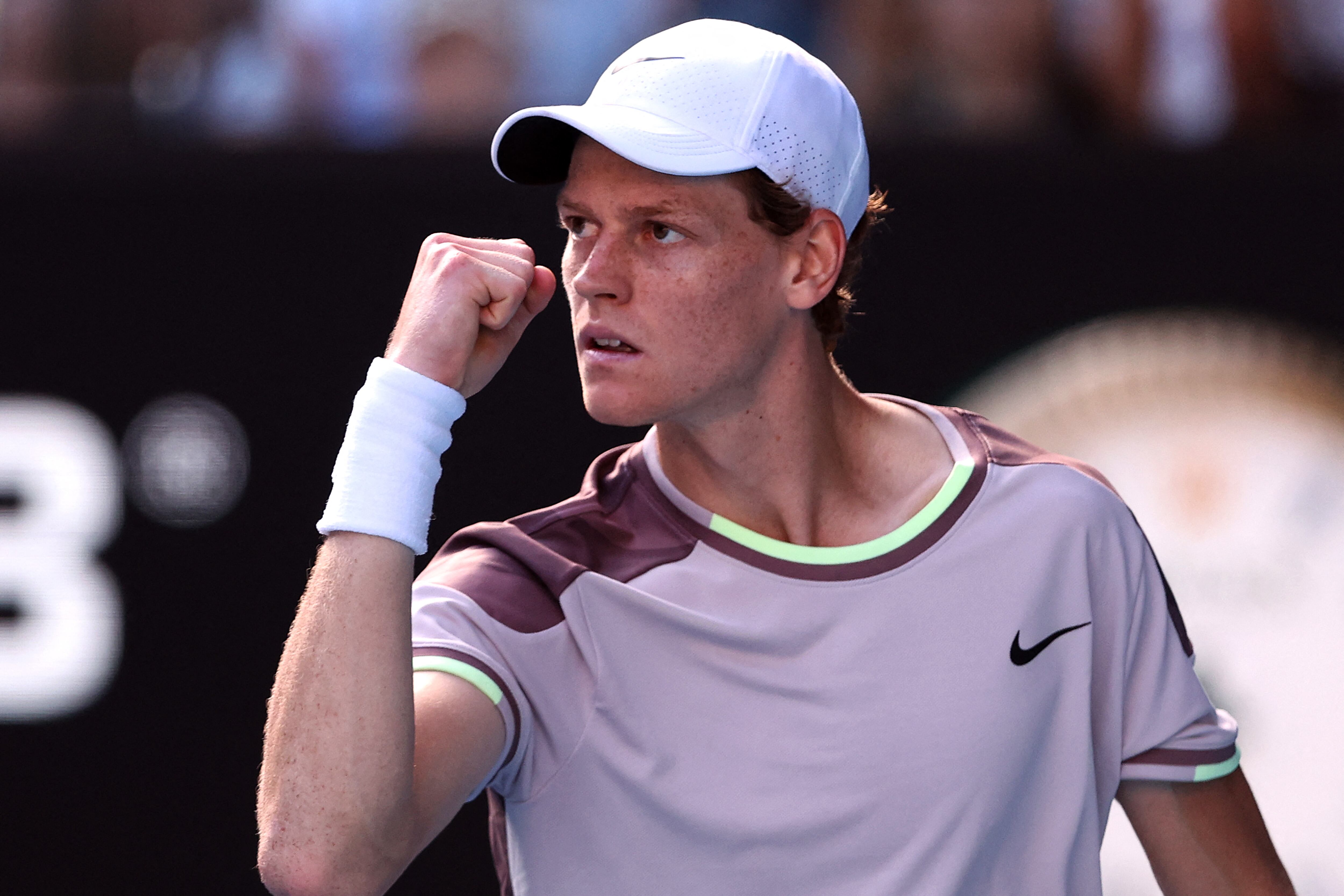Italy's Jannik Sinner reacts on a point against Serbia's Novak Djokovic during their men's singles semi-final match on day 13 of the Australian Open tennis tournament in Melbourne on January 26, 2024. (Photo by Martin KEEP / AFP) / -- IMAGE RESTRICTED TO EDITORIAL USE - STRICTLY NO COMMERCIAL USE --