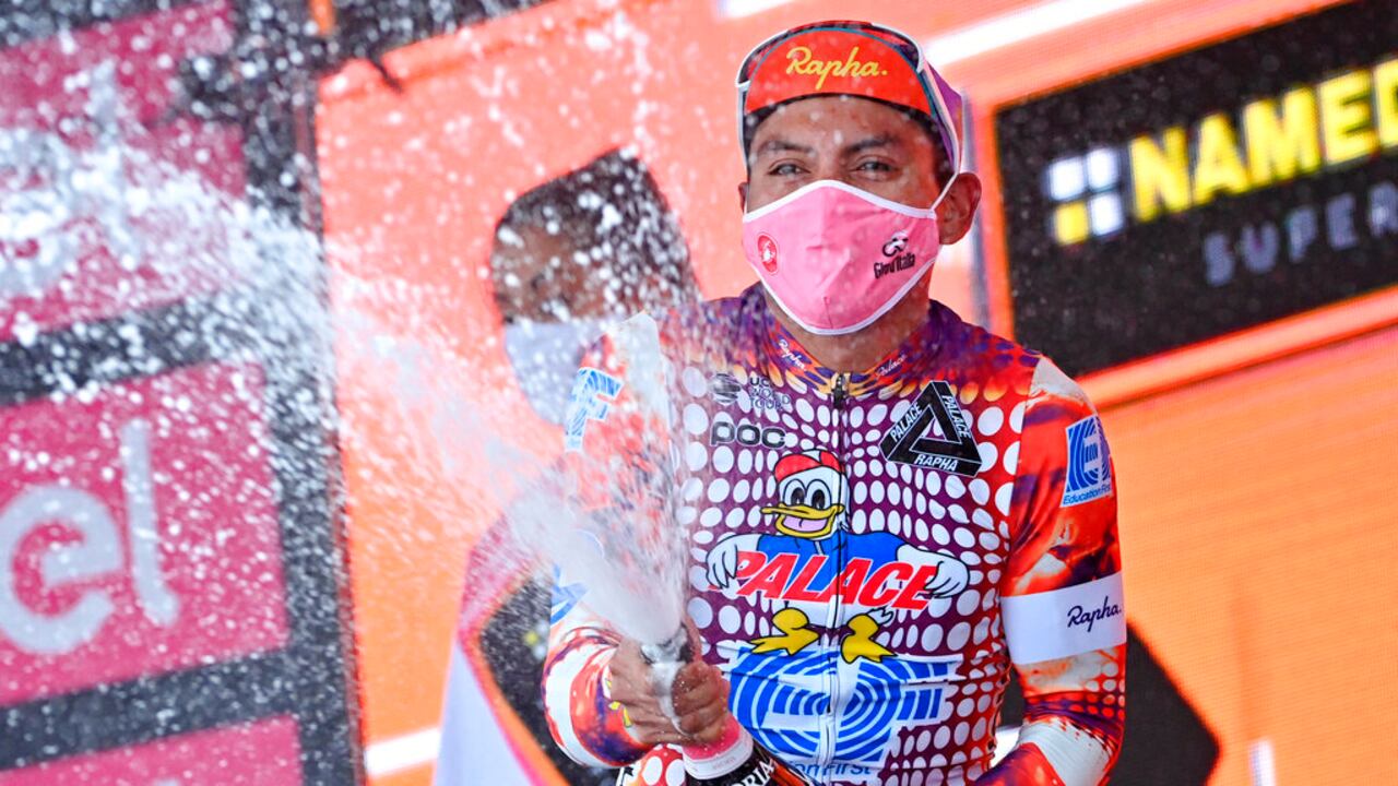 Ecuador's Jonathan Caicedo celebrates on the podium after winning the third stage of the Giro d'Italia, tour of Italy cycling race from Enna to Etna, Sicily, Monday, Oct. 5, 2020. (Gian Mattia D'Alberto/LaPresse via AP)