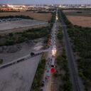 SAN ANTONIO, TX - JUNE 27: In this aerial view, members of law enforcement investigate a tractor trailer on June 27, 2022 in San Antonio, Texas. According to reports, at least 46 people, who are believed migrant workers from Mexico, were found dead in an abandoned tractor trailer. Over a dozen victims were found alive, suffering from heat stroke and taken to local hospitals. Jordan Vonderhaar/Getty Images/AFP (Photo by Jordan Vonderhaar / GETTY IMAGES NORTH AMERICA / Getty Images via AFP)