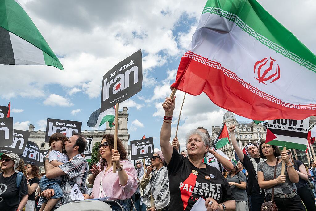 LONDON, ENGLAND - JUNE 14: Protestors chant in Parliament square against the Israeli attacks on Iran on June 14, 2025 in London, England. Protesters against Israel's attacks on Iran, are calling for the UK government to "stop arming Israel" and "End the Genocide" in Gaza. (Photo by Guy Smallman/Getty Images)