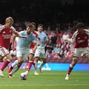 Arsenal's Martin Odegaard, left, scores his side's third goal during the FA Community Shield final soccer match between Arsenal and Manchester City in Cardiff, Wales, Sunday, Aug.16, 2026. (AP Photo/Alastair Grant)