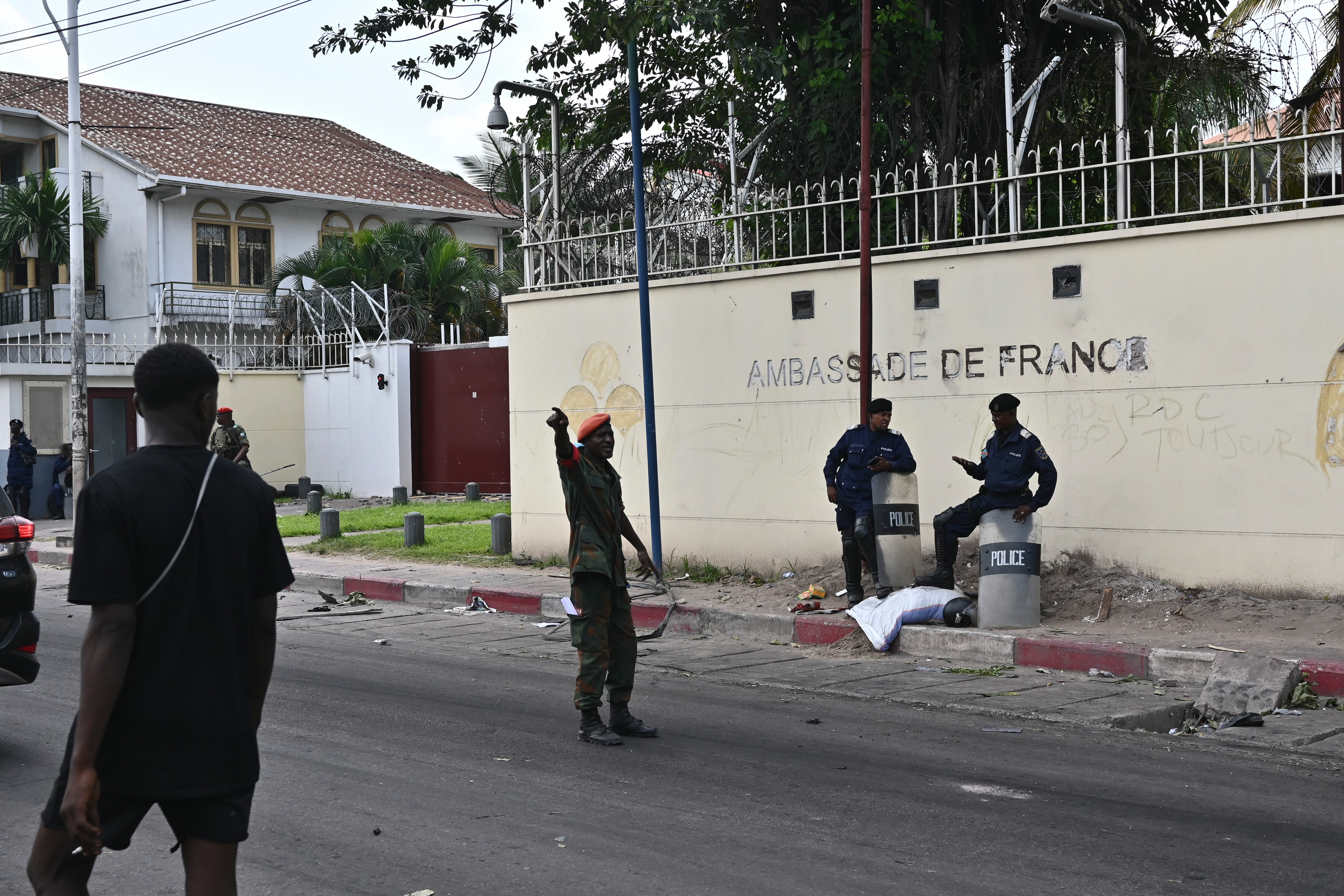 Congolese security personnel stand in front of the French Embassy in Kinshasa, Democratic Republic of the Congo Tuesday, Jan. 28, 2025, after it was attacked  by demonstrators protesting the Rwanda-backed M23 rebels' advances into eastern Congo's capital Goma. (AP Photo/Samy Ntumba Shambuyi)