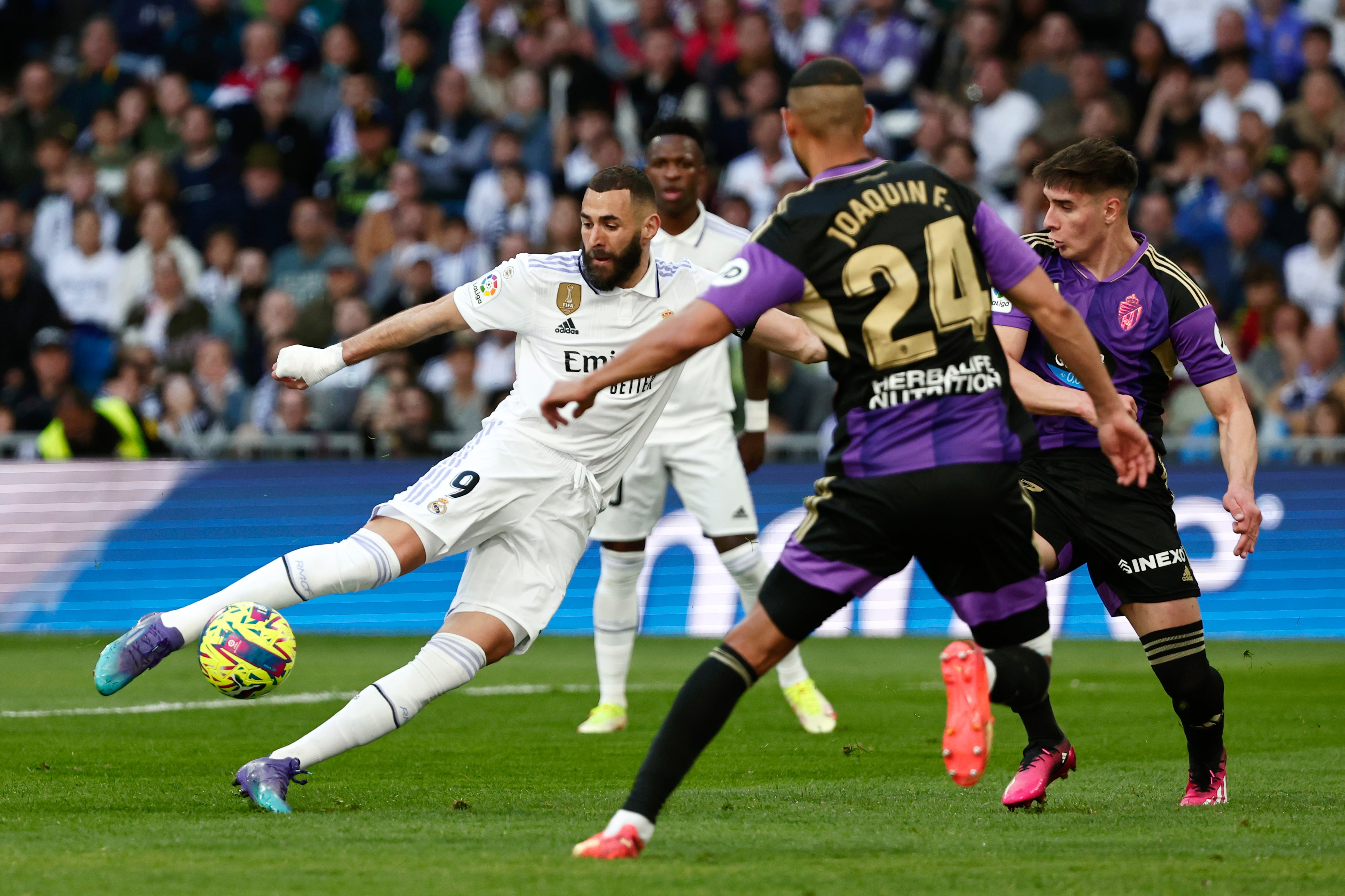 Real Madrid's Karim Benzema, left, attempts a shot at goal in front of Valladolid's Joaquin during a Spanish La Liga soccer match between Real Madrid and Valladolid at the Santiago Bernabeu stadium in Madrid, Spain, Sunday, April 2, 2023. (AP Photo/Pablo Garcia)