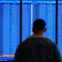 A traveler looks at a flight board with delays and cancellations at Ronald Reagan Washington National Airport in Arlington, Va., Wednesday, Jan. 11, 2023. Flights are being delayed at multiple locations across the United States after a computer outage at the Federal Aviation Administration. (AP Photo/Patrick Semansky)
