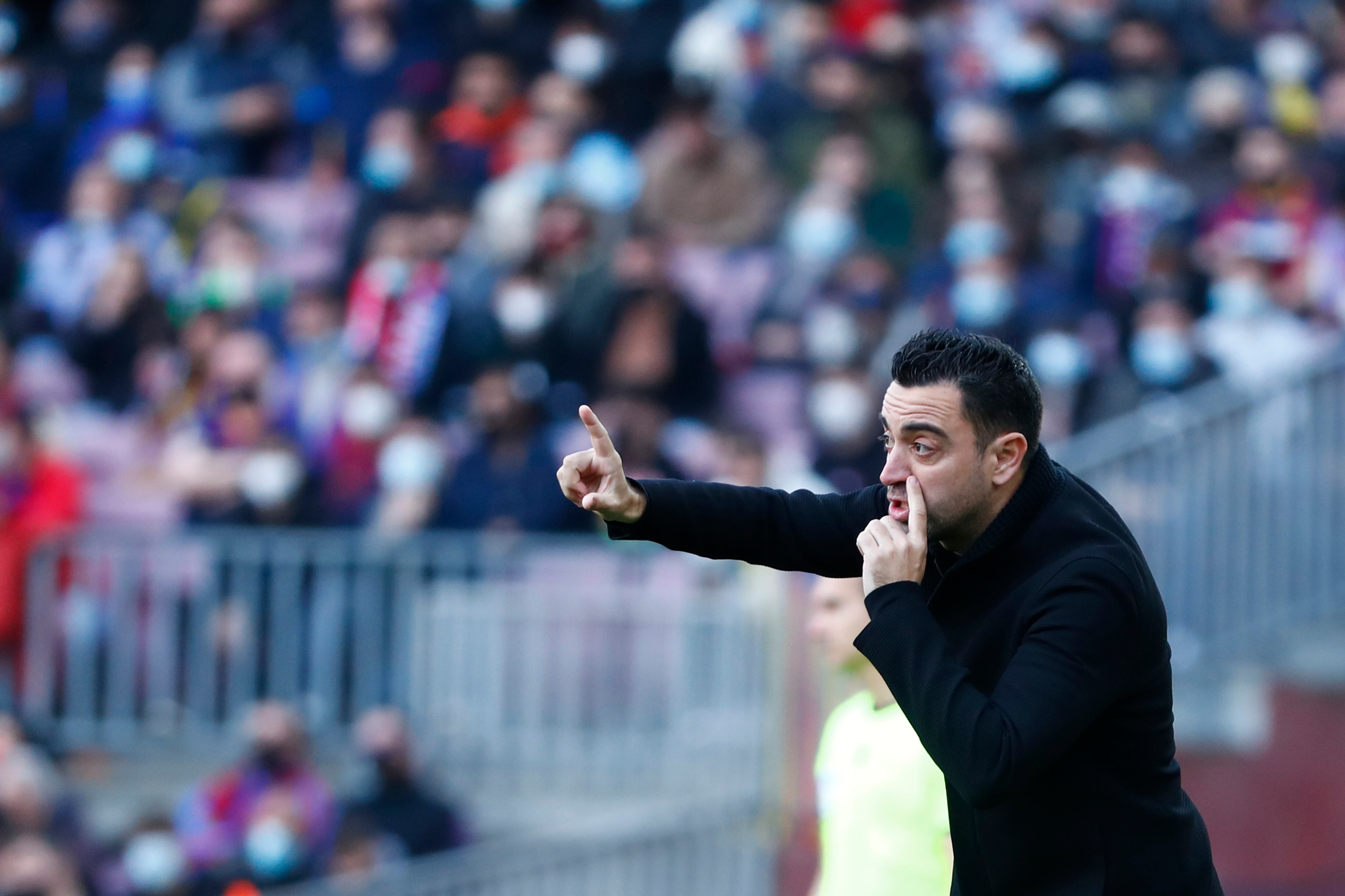 Barcelona's head coach Xavi Hernandez gives instructions from the side line during a Spanish La Liga soccer match between FC Barcelona and Atletico Madrid at the Camp Nou stadium in Barcelona, Spain, Sunday, Feb. 6, 2022. (AP Photo/Joan Monfort)