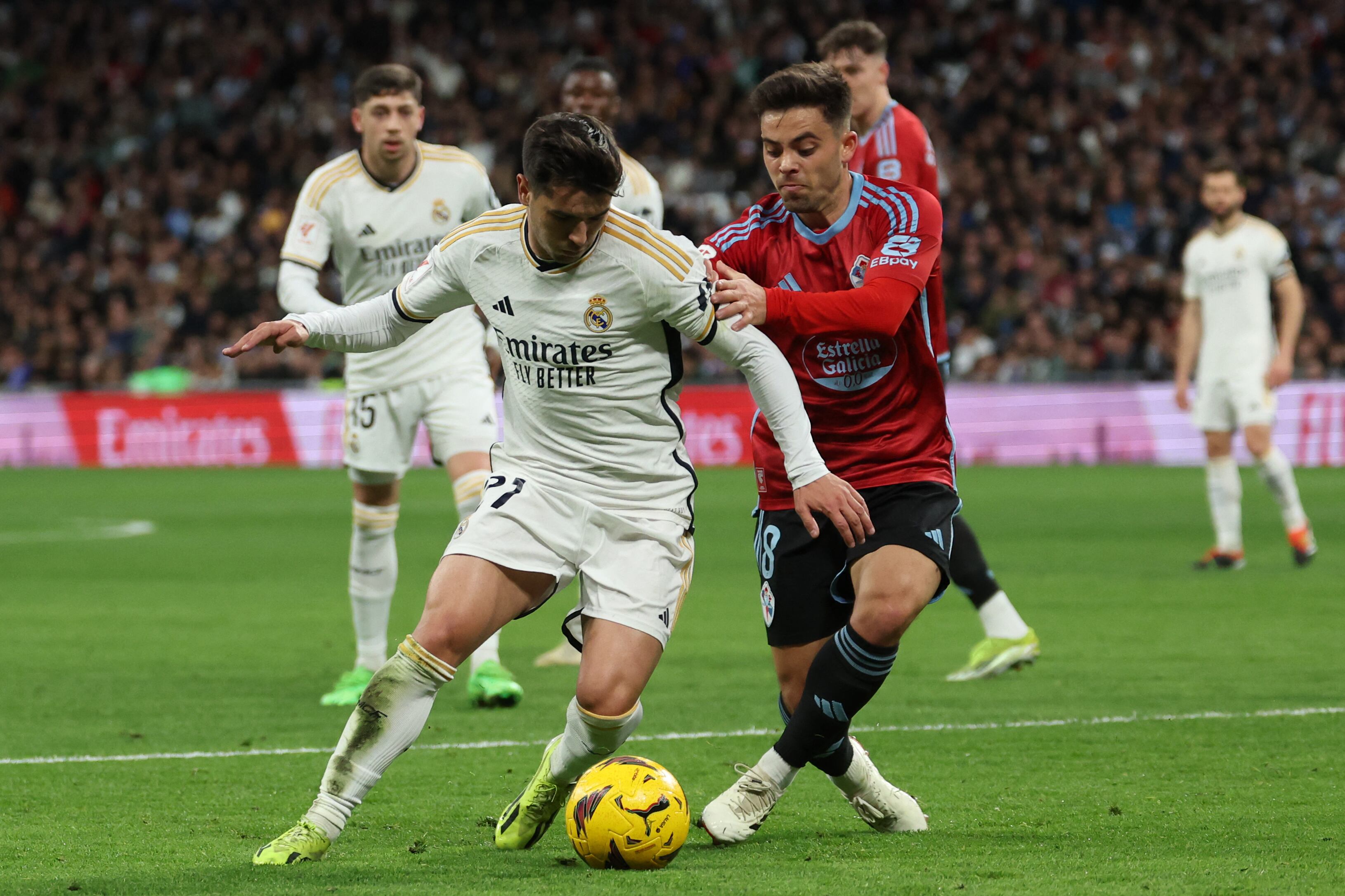 Real Madrid's Spanish forward #21 Brahim Diaz fights for the ball with Celta Vigo's Spanish midfielder #08 Fran Beltran during the Spanish league football match between Real Madrid CF and RC Celta de Vigo at the Santiago Bernabeu stadium in Madrid on March 10, 2024. (Photo by Pierre-Philippe MARCOU / AFP)