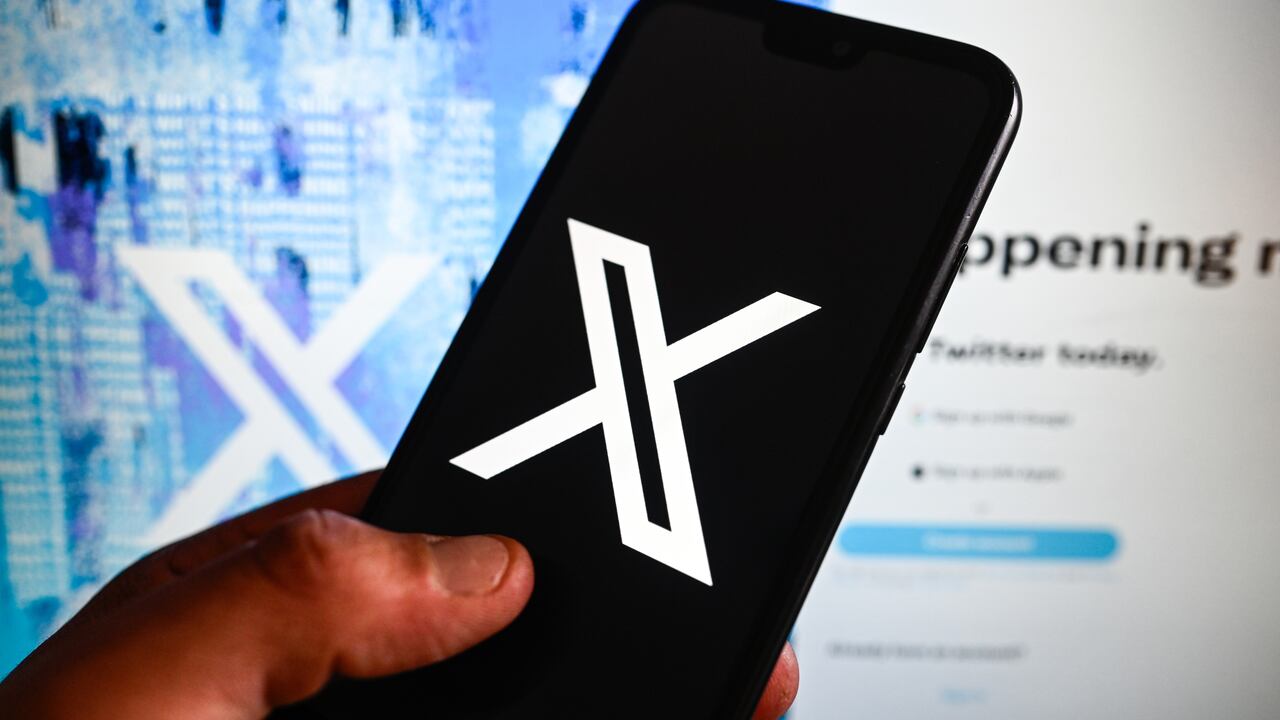 POLAND - 2023/07/28: In this photo illustration a New Twiiter logo (X) is displayed on a smartphone with Twitter website in the background. (Photo Illustration by Omar Marques/SOPA Images/LightRocket via Getty Images)