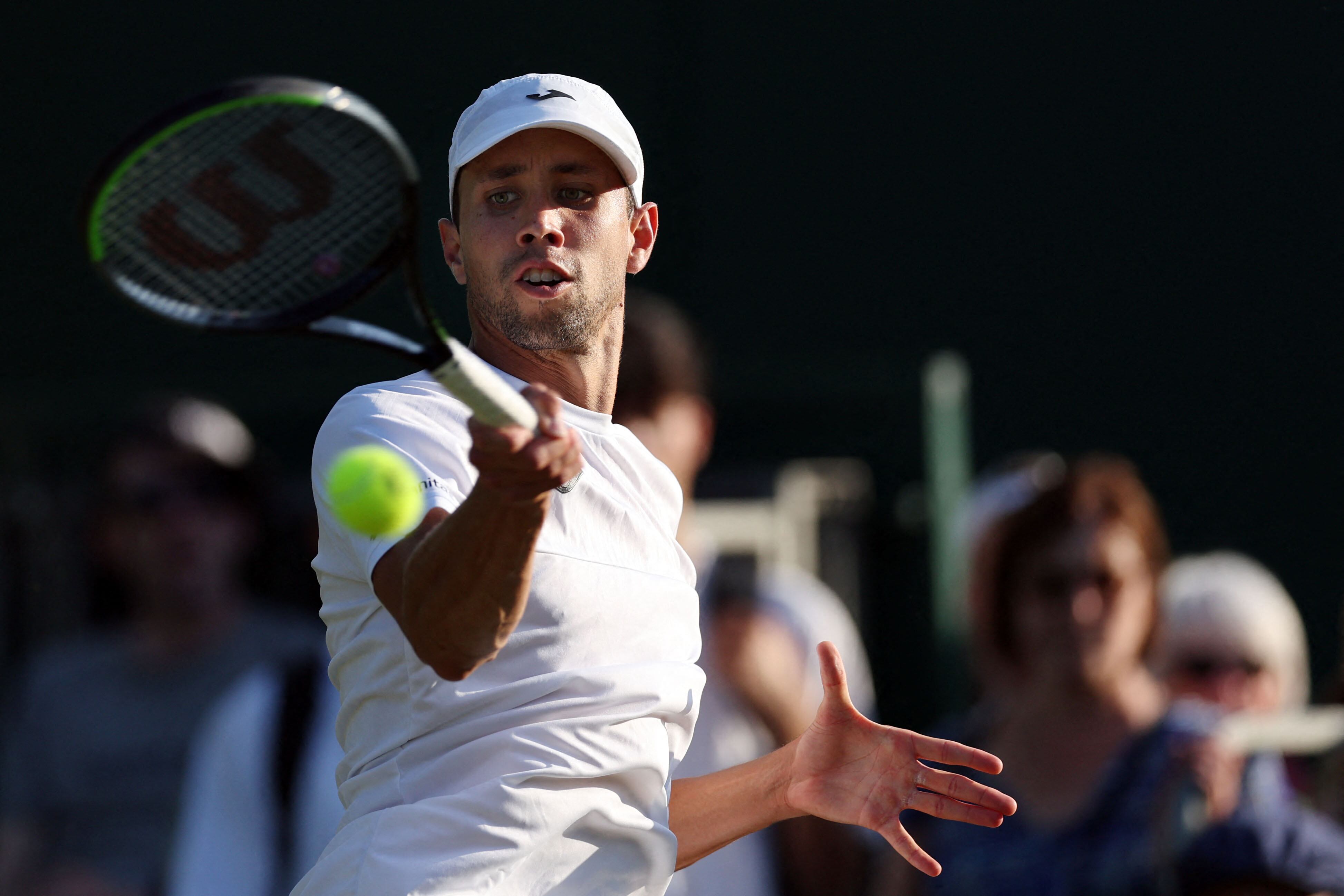 Colombia's Daniel Elahi Galan returns the ball to Sweden's Mikael Ymer during their men's singles tennis match on the fifth day of the 2023 Wimbledon Championships at The All England Tennis Club in Wimbledon, southwest London, on July 7, 2023. (Photo by Adrian DENNIS / AFP) / RESTRICTED TO EDITORIAL USE