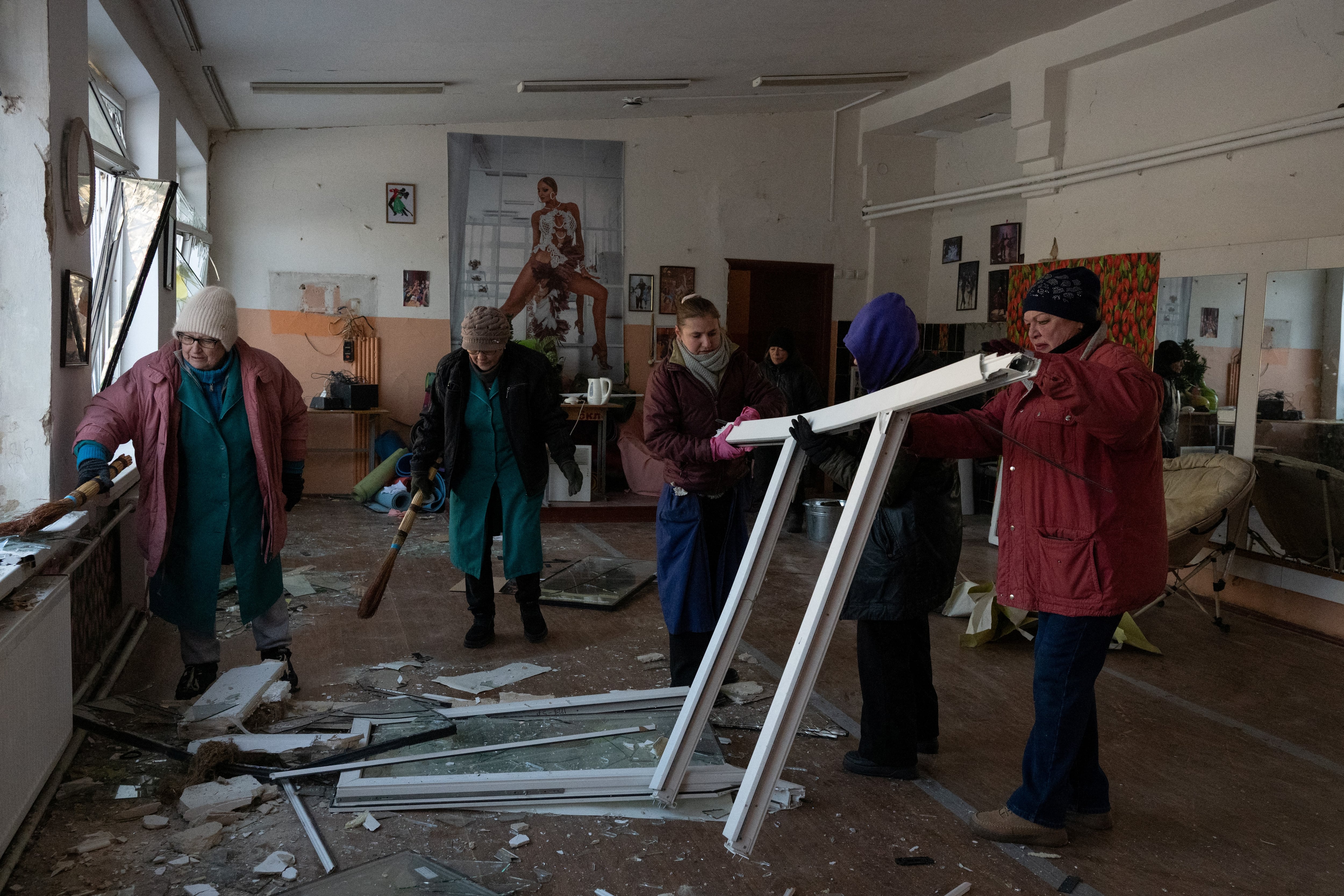 Mujeres limpian escombros en una clase de baile escolar dañada tras un ataque aéreo en Kiev el 3 de febrero de 2026.