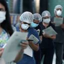 Enfermeras y médicos esperan en la fila para recibir una inyección de la vacuna Sinopharm de China durante una campaña prioritaria de vacunación COVID-19 en un hospital público en Lima, Perú. (AP Foto/Martin Mejia)