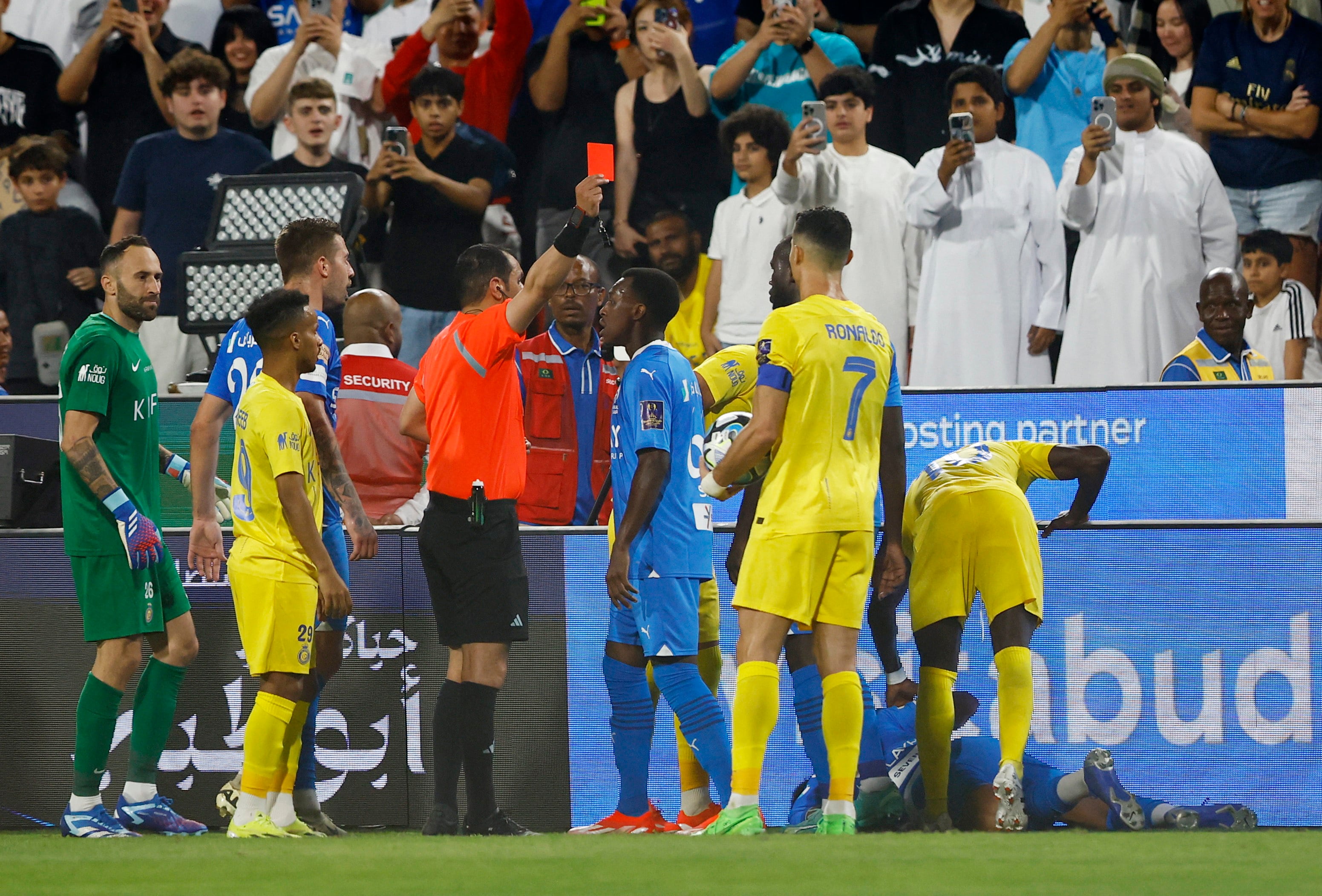 Soccer Football - Saudi Super Cup - Semi Final - Al Hilal v Al Nassr - Mohammed bin Zayed Stadium, Abu Dhabi, United Arab Emirates - April 9, 2024 Al Nassr's Cristiano Ronaldo is shown a red card by referee Mohammed Al Hoaish after clashing with Al Hilal's Ali Al Bulayhi REUTERS/Rula Rouhana