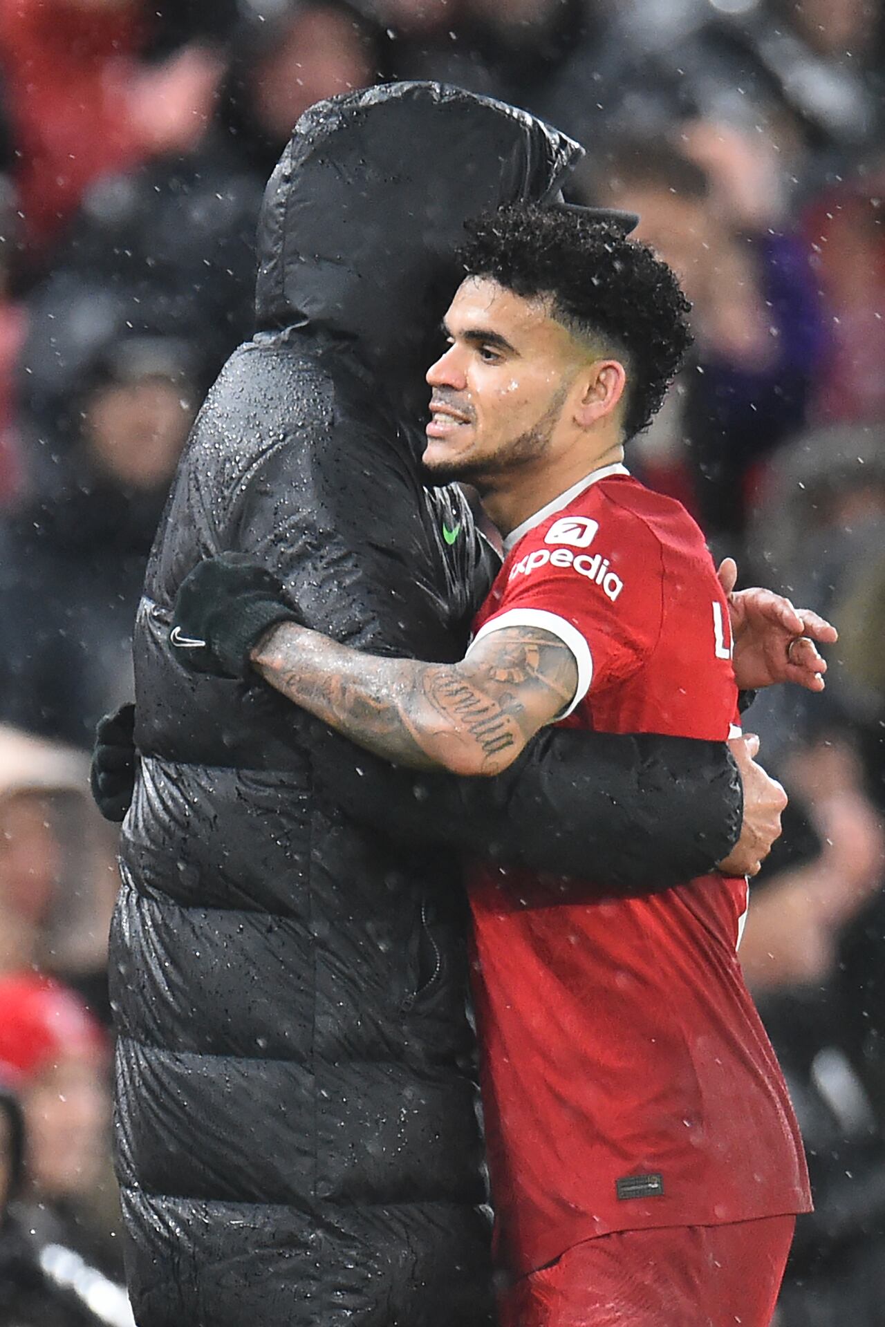 Liverpool's German manager Jurgen Klopp (L) embraces Liverpool's Colombian midfielder #07 Luis Diaz (R) after he is substituted during the English Premier League football match between Liverpool and Newcastle United at Anfield in Liverpool, north west England on January 1, 2024. (Photo by PETER POWELL / AFP) / RESTRICTED TO EDITORIAL USE. No use with unauthorized audio, video, data, fixture lists, club/league logos or 'live' services. Online in-match use limited to 120 images. An additional 40 images may be used in extra time. No video emulation. Social media in-match use limited to 120 images. An additional 40 images may be used in extra time. No use in betting publications, games or single club/league/player publications. /