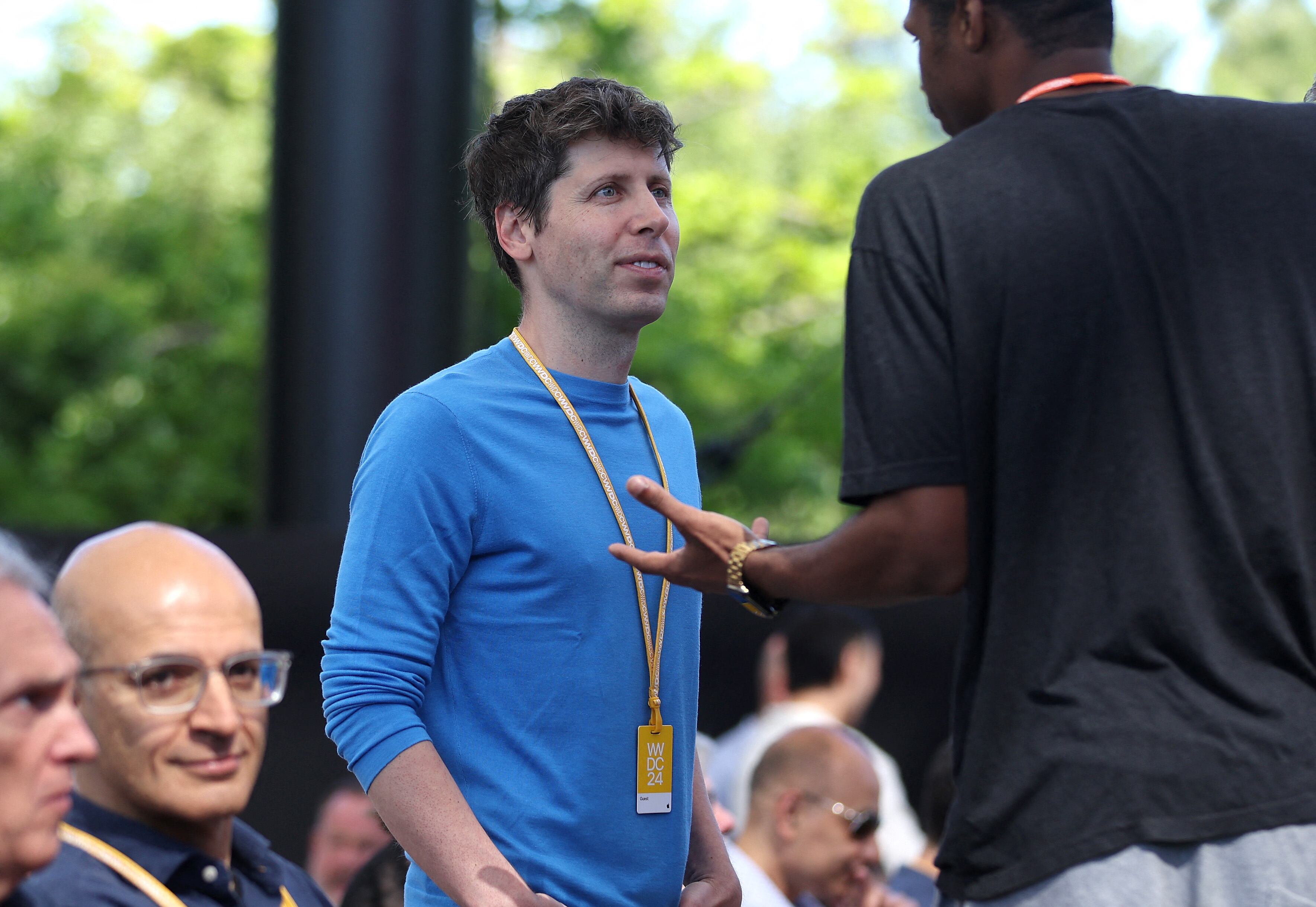 CUPERTINO, CALIFORNIA – 10 DE JUNIO: El director ejecutivo de OpenAI, Sam Altman (de azul), habla con un asistente durante la Conferencia Mundial de Desarrolladores de Apple (WWDC). (Foto de JUSTIN SULLIVAN / GETTY IMAGES NORTEAMÉRICA / Getty Images vía AFP)